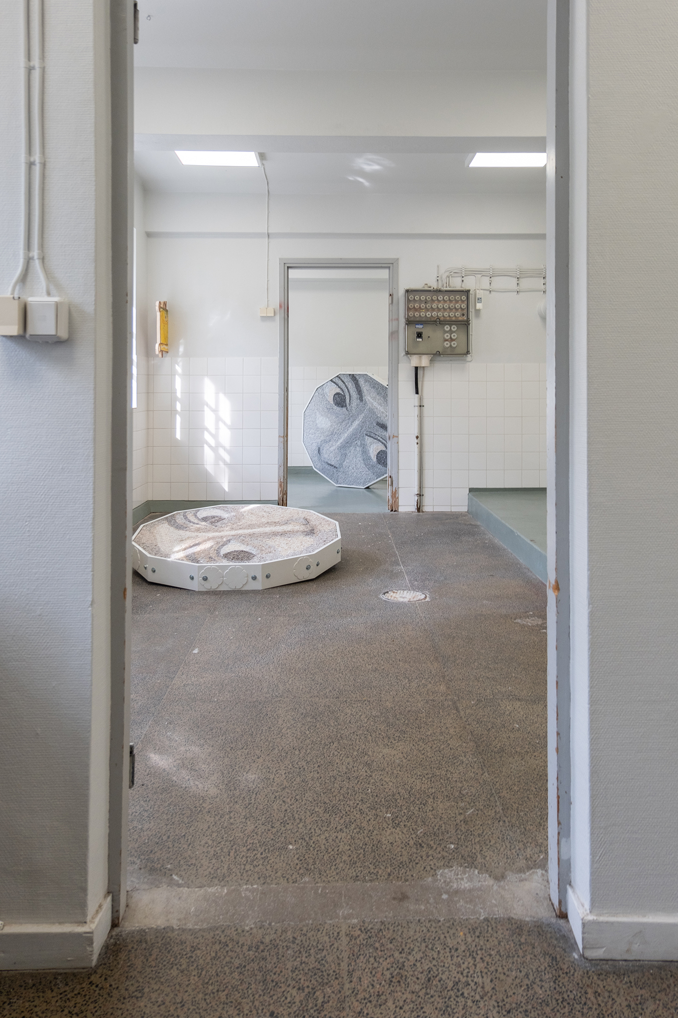 On the floor: "Lost in the field of wild daisies", marble, bolts, painted mdf, 2024 / Riikka Anttonen On the wall: "45°C", 50x72 cm, oil on canvas, wood, 2024 / Kerttu Saali
