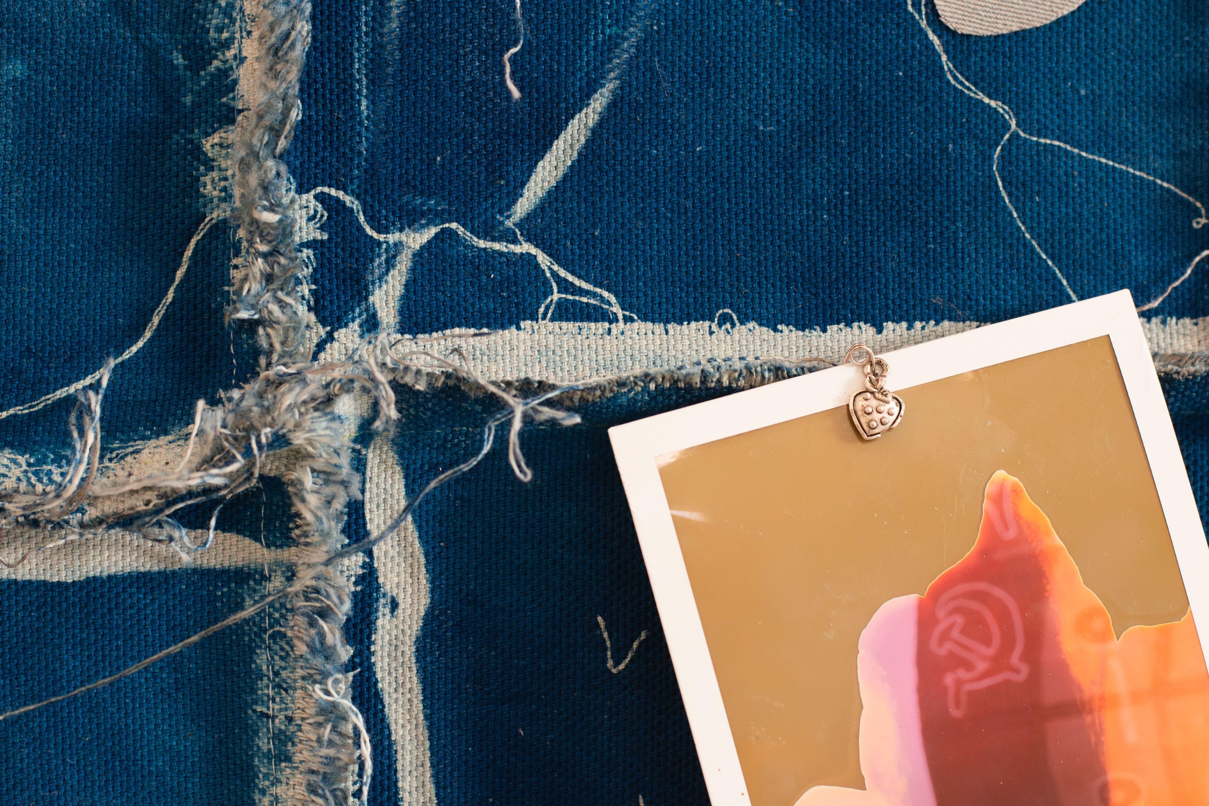 Maya Hottarek, Offgrid, cyanotype on cotton, wood, aluminium cast, polaroid, safety pin, lucky charm, 2024. Second Impressions, 14.09-20.10.24, KOMPLOT. Image Sara Hamedi