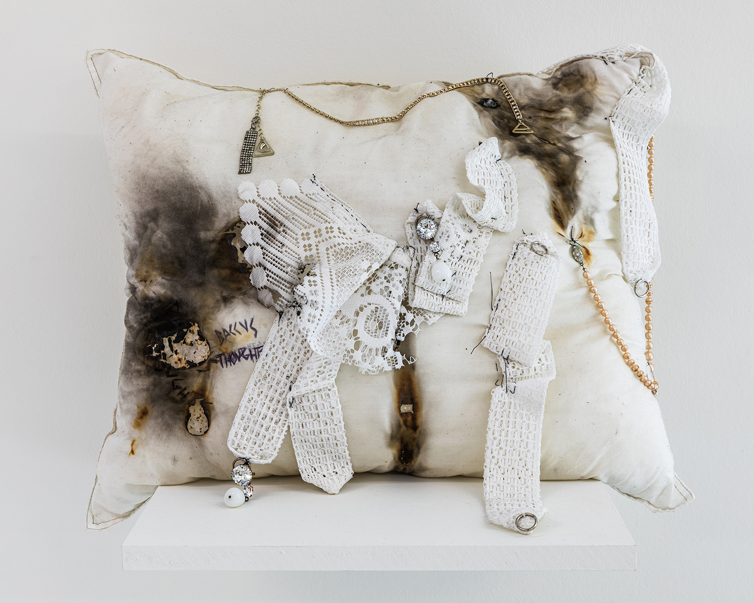 Exhibition view; Élie Autin, Pillow, 2023, hand-sewn cushion with sewn additions, 60 x 50cm, CALM - Centre d'Art La Meute, Lausanne, Switzerland, 2024 / Photo: Théo Dufloo / Courtesy of the artist and CALM - Centre d'Art La Meute.
