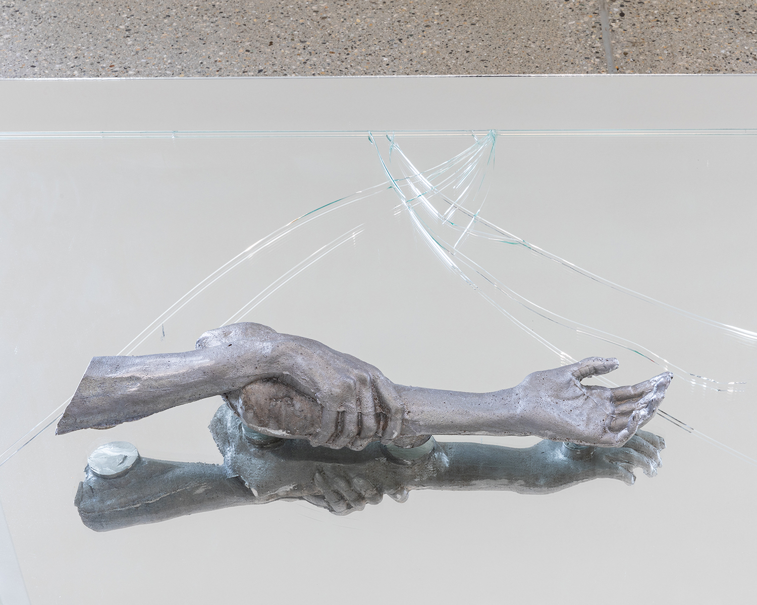 Exhibition view; Emma Passera, 7 days without you, 2024, detail, aluminium arm and leg, mirror, glass, 260 x 130cm, CALM - Centre d'Art La Meute, Lausanne, Switzerland, 2024/Photo: Théo Dufloo/Courtesy of the artist and CALM - Centre d'Art La Meute.