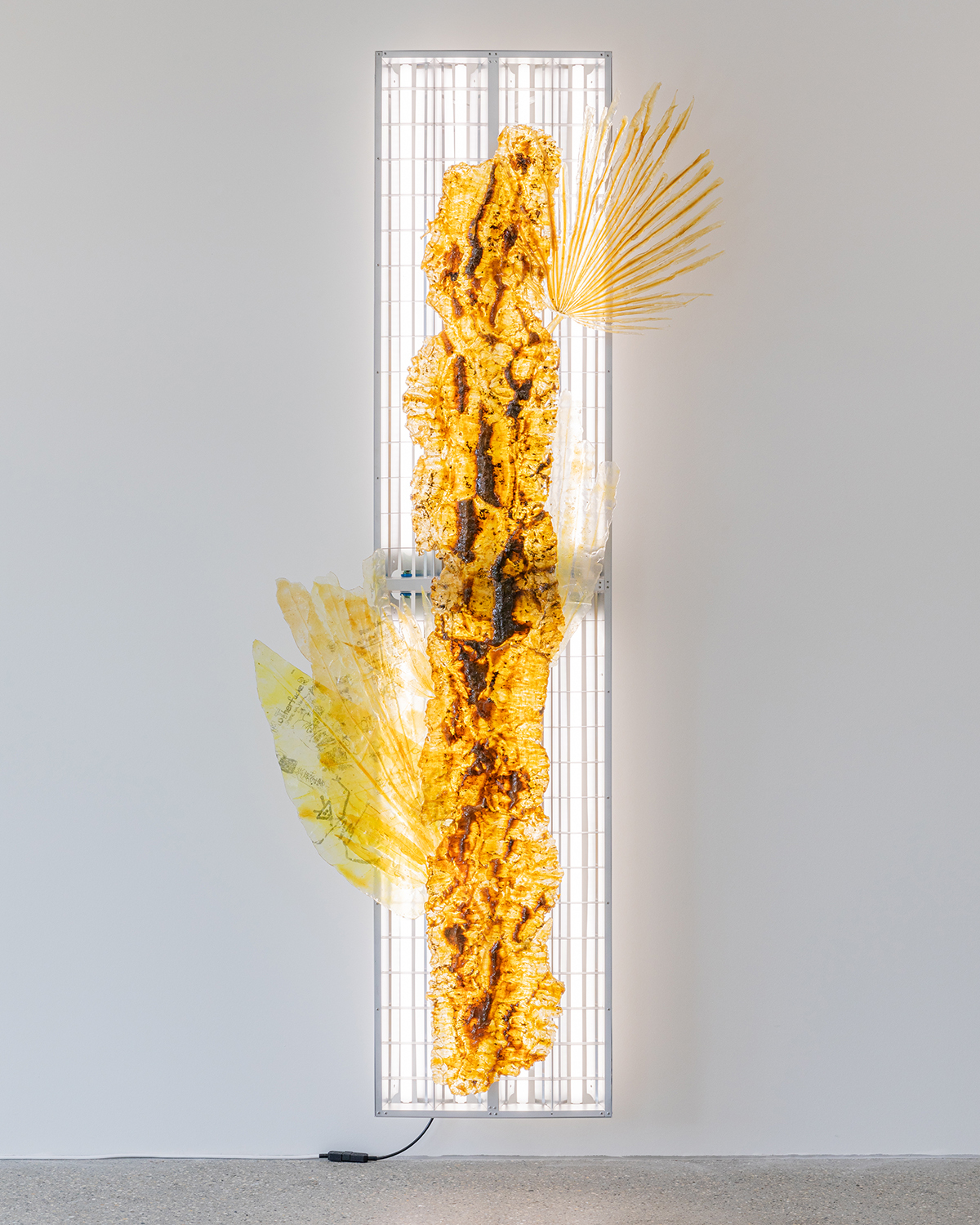Exhibition view; Chloé Delarue, TAFAA - UNNECESSARY DOUBT (SNITCH II), 2024, latex, resin, transfer print, fluorescent tubes, 240x90x20cm, CALM-Centre d'Art La Meute, 2024/Photo: Théo Dufloo/Courtesy of the artist, galerie frank elbaz and CALM.