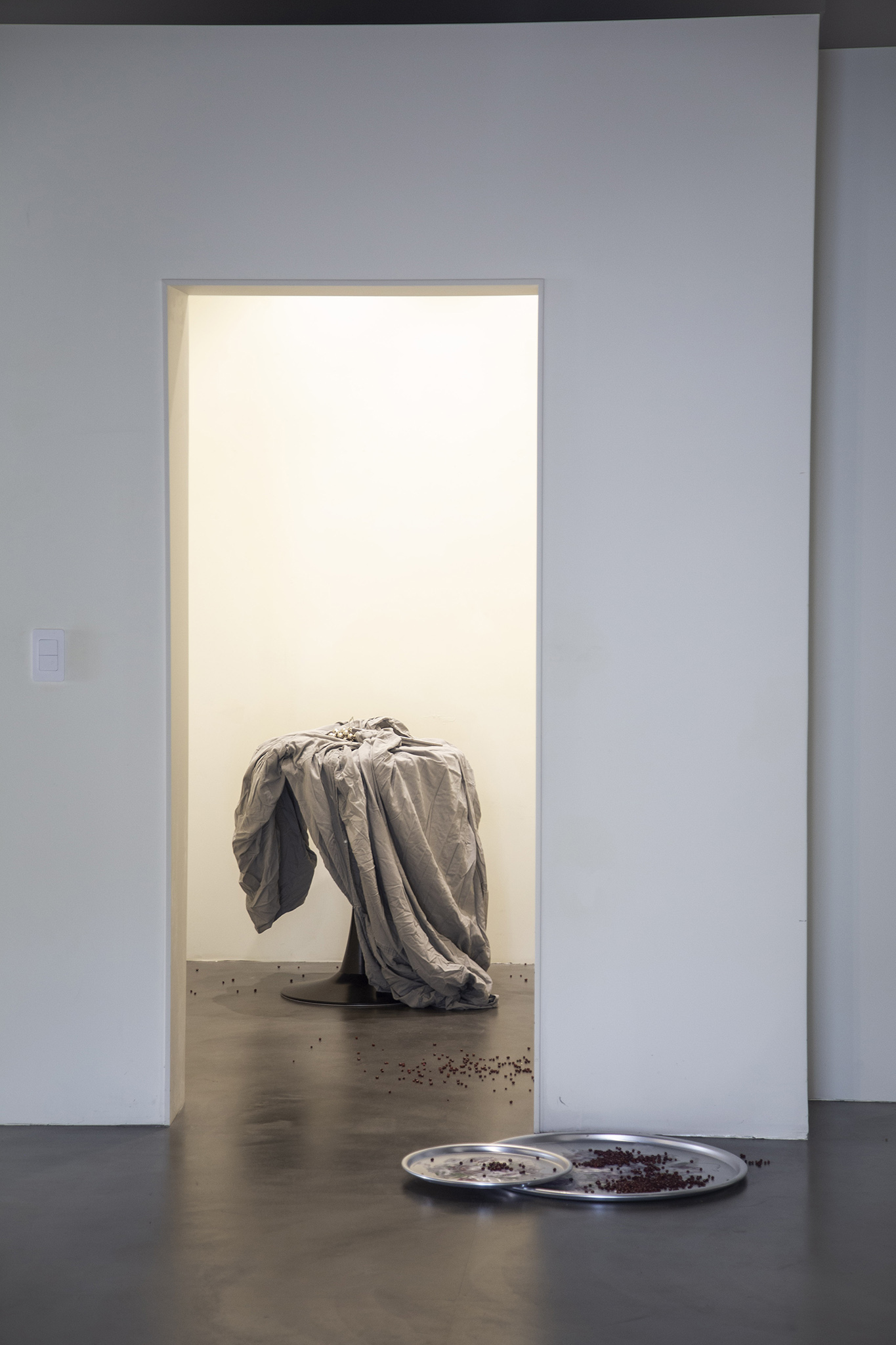 With the Steps of the Ghostly Matters, 2024, Site-specific installation, tin coated trays, red beans, blankets of recently deceased people, bells and steel