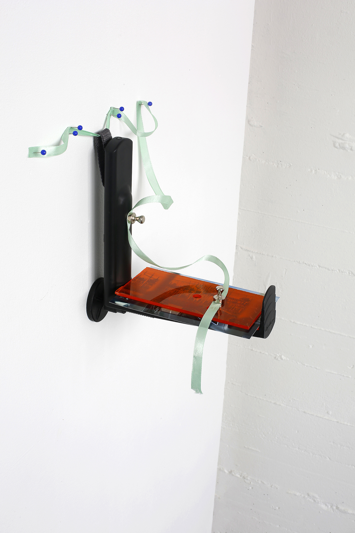Tuomas Lehtomaa: Untitled, 2024. flower box bracket, plexiglas, photograph, magnets, ribbon, pins