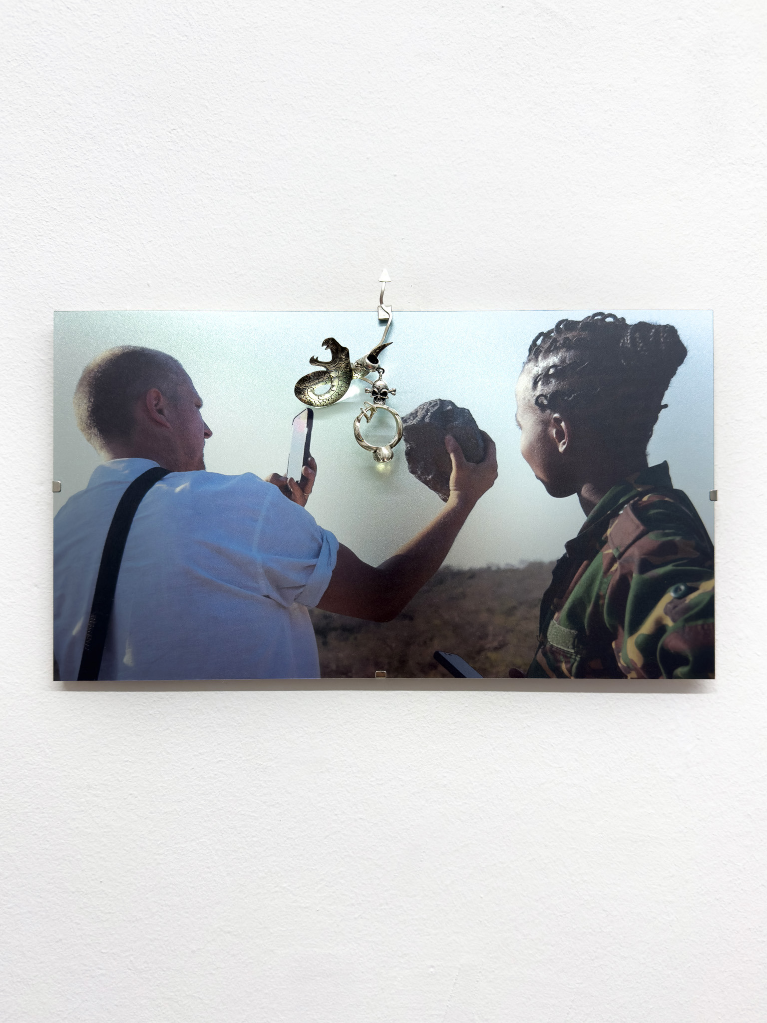 Daniel Hopp with  Hellena Hueck,  Bought With Pleasure I, 2024, sterling silver, found snake brooch, found ring, spring steel, cardboard, metal print, 16,8 x 30cm, Sprink Düsseldorf