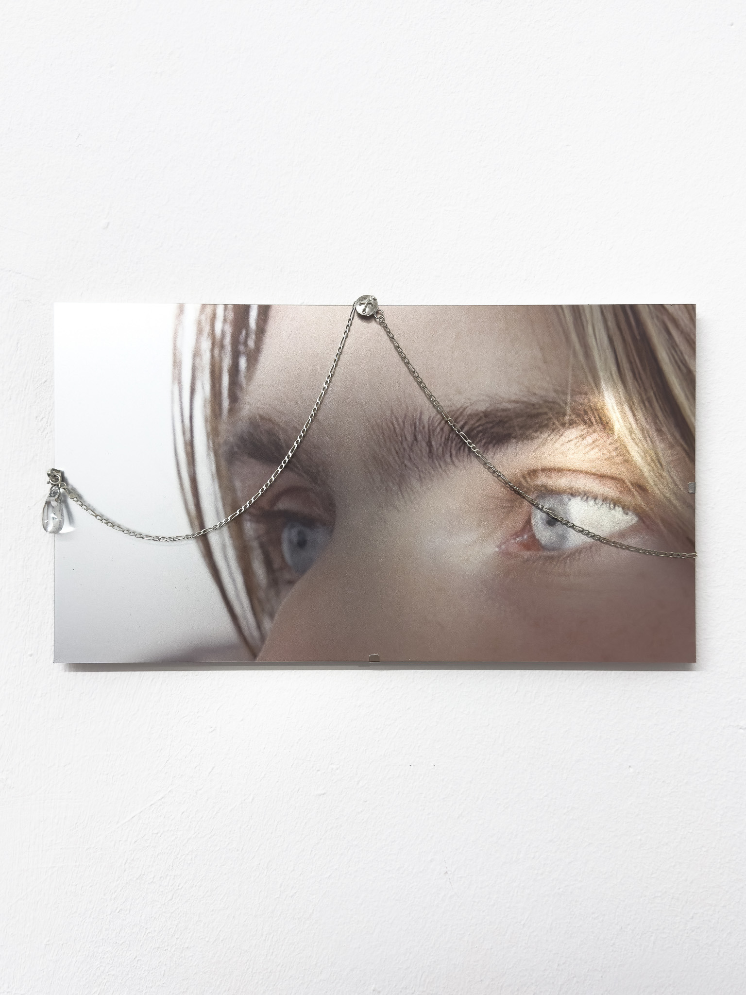 Daniel Hopp with  Hellena Hueck,  Bought With Pleasure II, 2024, sterling silver, glass drop, silver chain, spring steel, cardboard, metal print, 16,8 x 30cm, Sprink Düsseldorf
