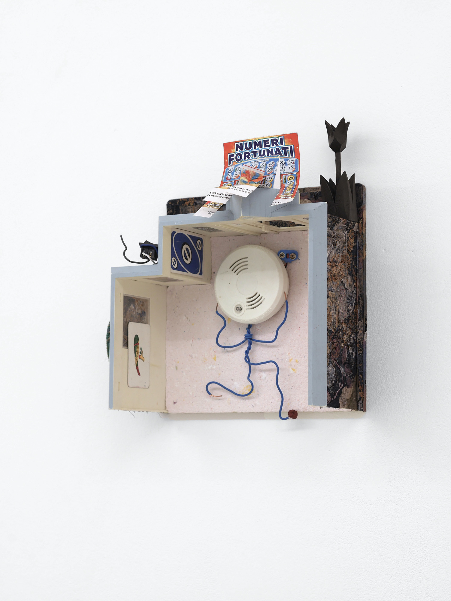 dylan ray arnold, Numeri Fortunati, smoke-detector, lottery-ticket, rowan berry, dollhouse, textile, playing cards, light switch, paper cut-outs, wooden flower, scratch card, shoulder-pad, balt-cutter, stone, modeling wax, 2024. Photo: dylan ray arnold