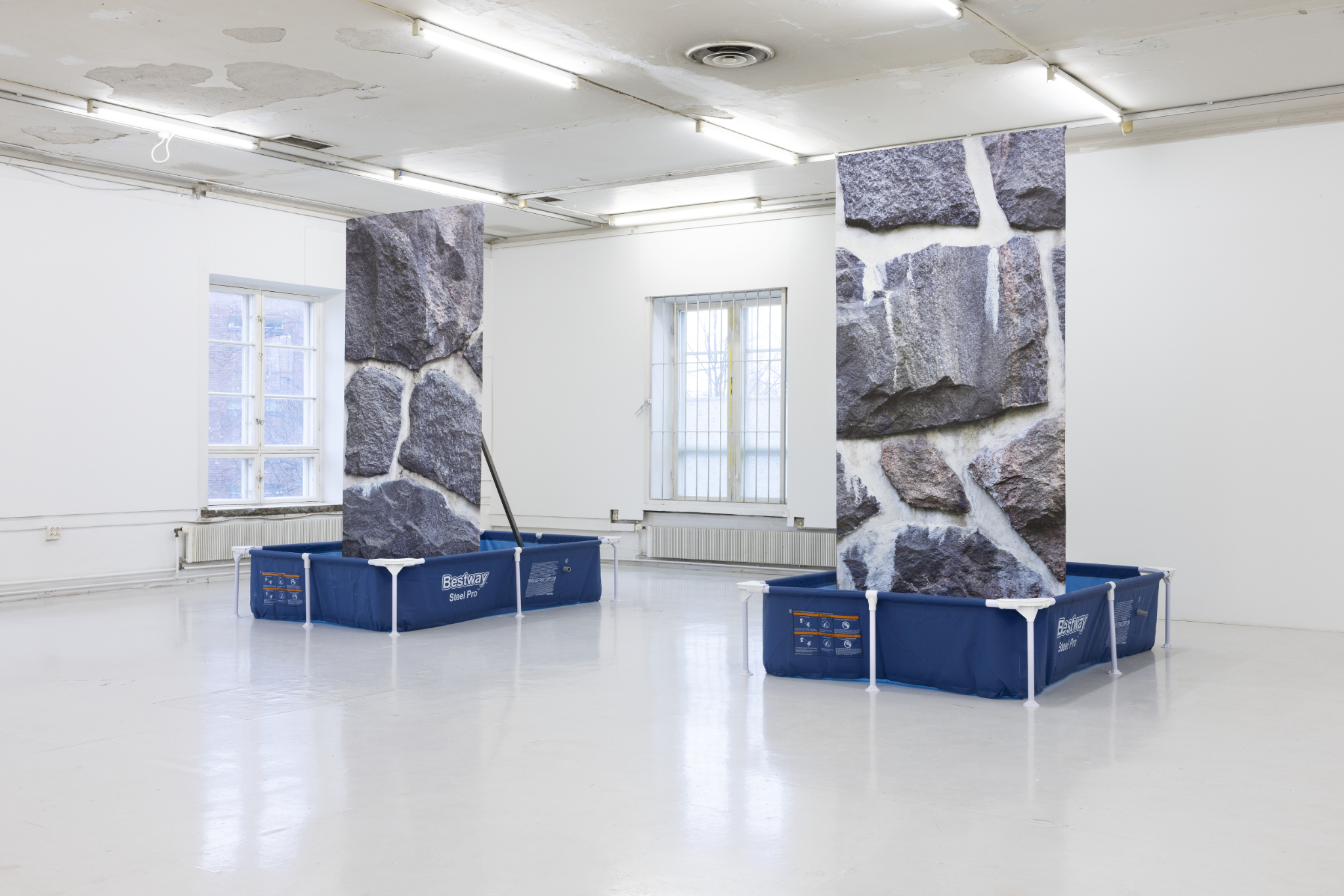 Kosteaa muuria, 2024  Two Bestway-swimming pools, water, blueback prints mounted on osb-board, aluminum, support structure 2 x 221 x 150 x 260 cm