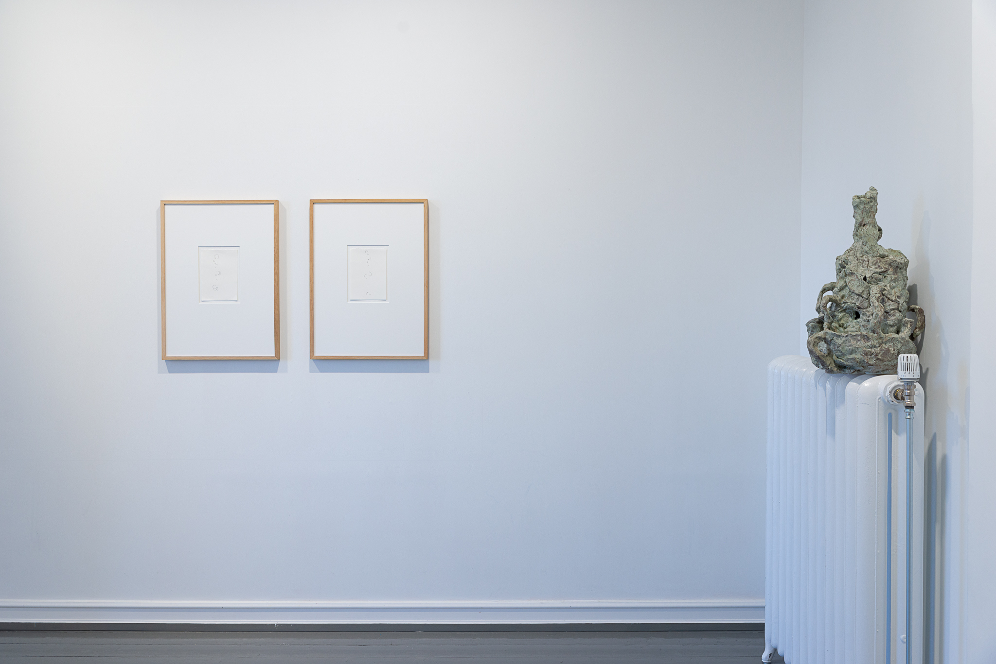 Installation view (the View), with Untitled ( figure study), (2024), Graphite on paper, and Untitled (Pot for radiator), (2024) Glazed stoneware. Courtesy of the artist and Norwegian Sculptors Society