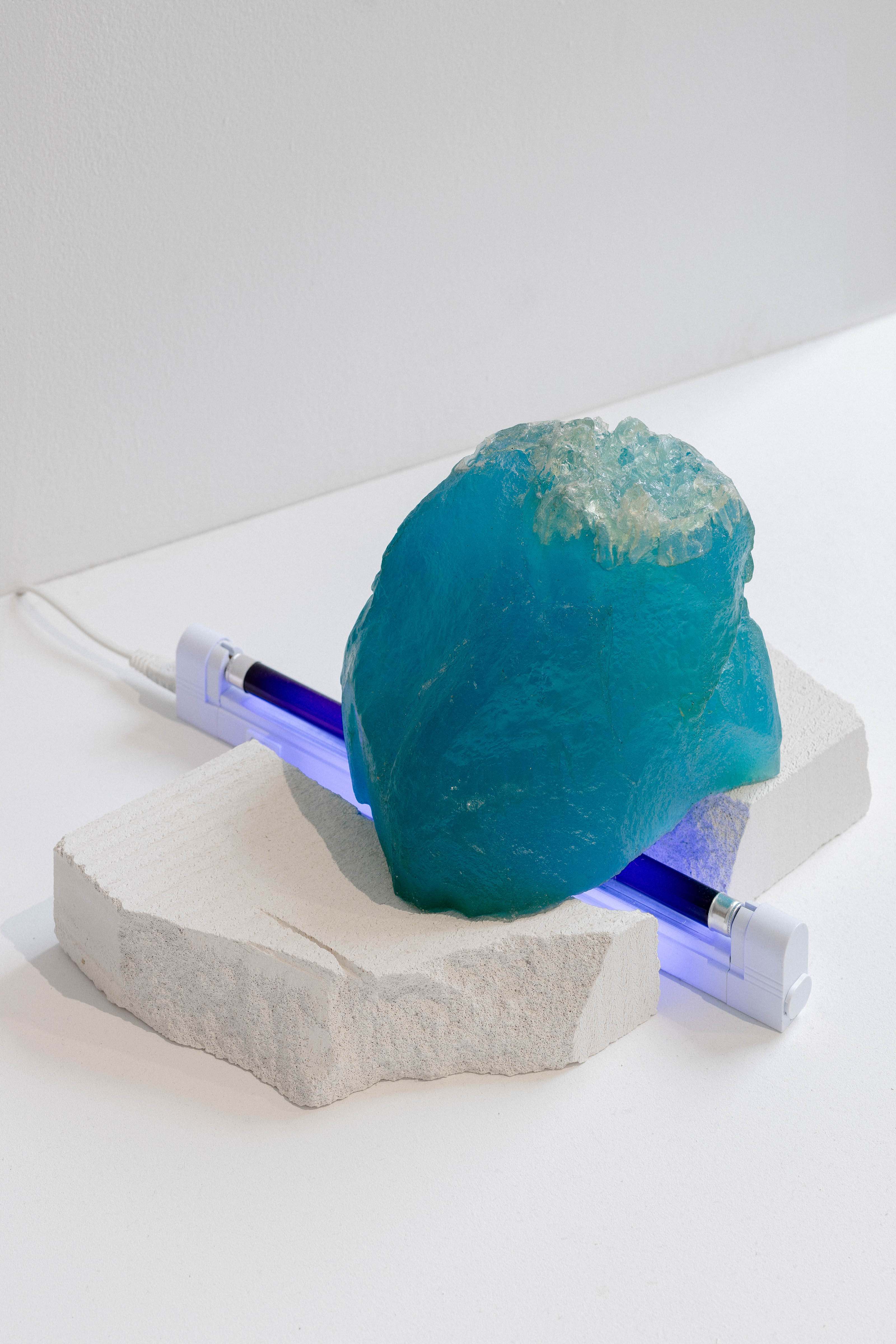 Marta Krześlak, The Melting Iceberg, installation; epoxy resin, cement, fluorescent lamp, cable, 2018. From the collections of the Muzeum Sztuki, Łódź