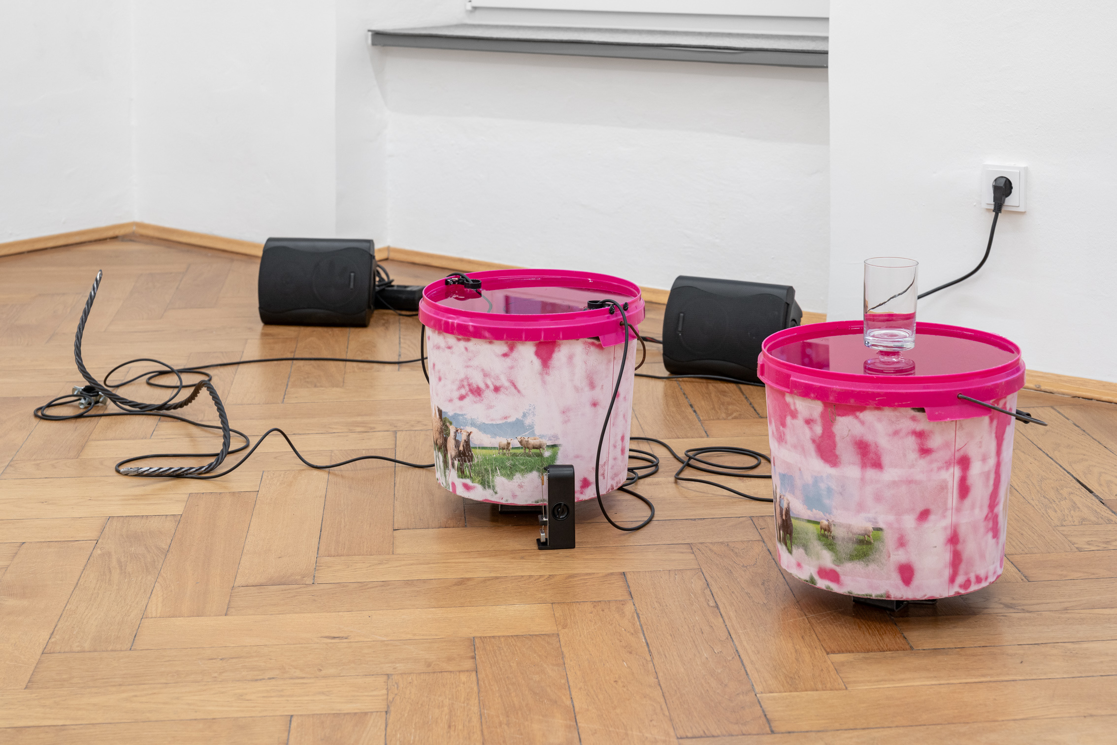 Lauren Gault, "macalla (echo 1)", 2024, empty mineral buckets, glass, glass jug, mechanical metronome, two hydrophones, scarlett audio device, speakers, cabling, metal fixture, metal rope, metal base, water, size variable