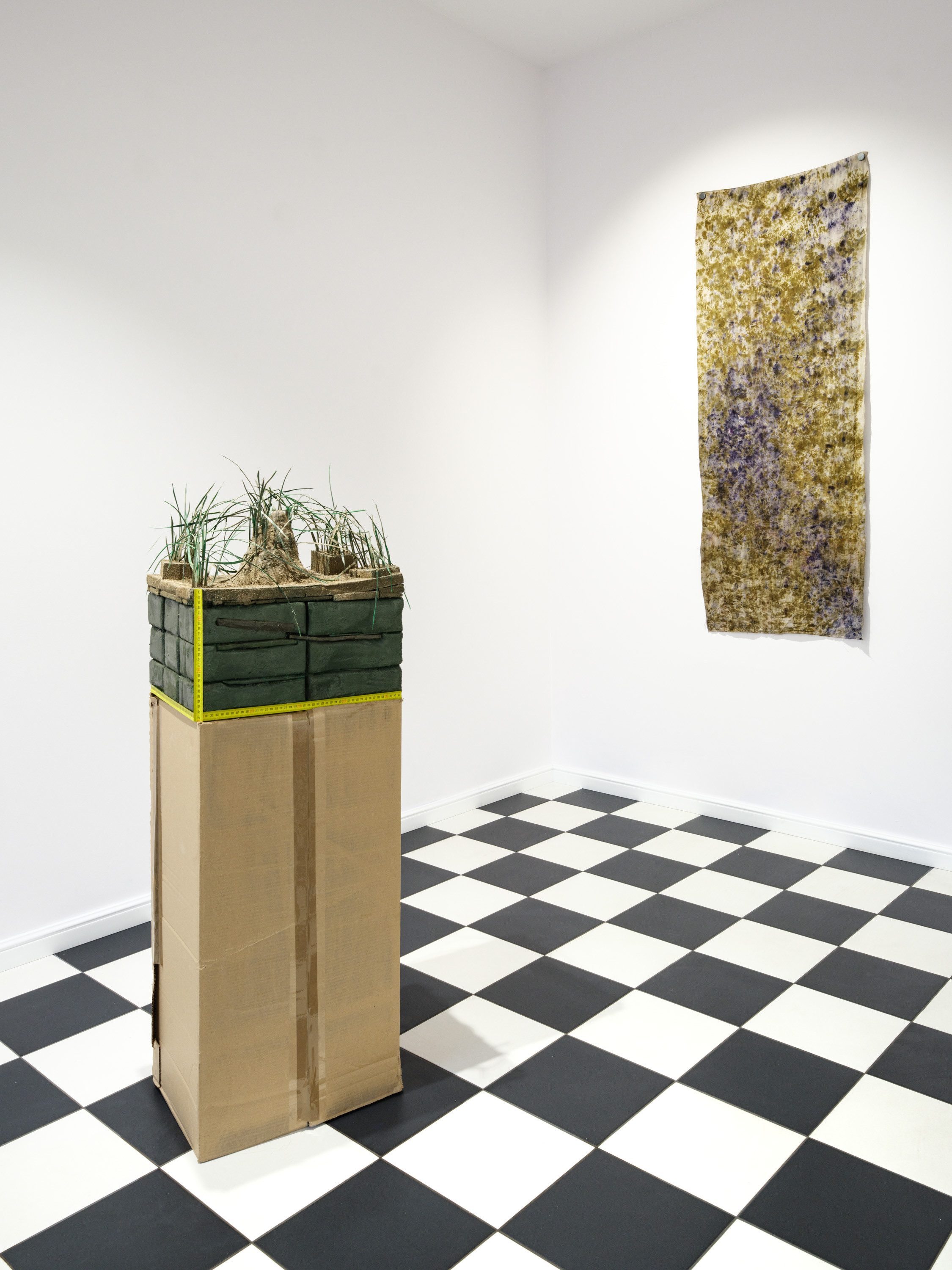 Piotr Kowalski "Soil cross-section", 2024, flower foam, plastic, clay, measuring tape, 50 x 45 x 32 cm, Julia Ciunowicz "Untitled", 2024, cotton dyed naturally with black hollyhock and onion