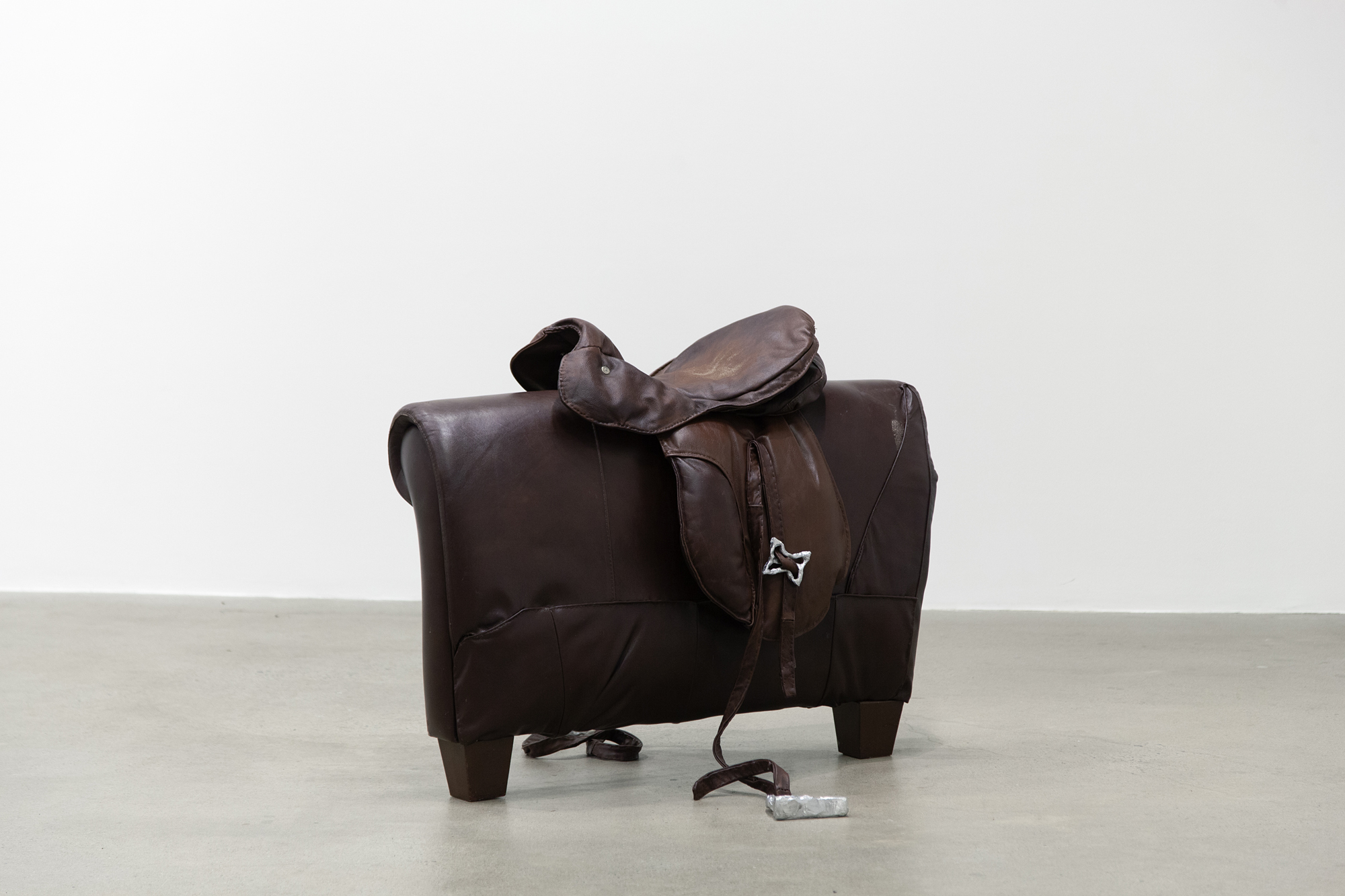 Cindy Hill, "Bridle Fantasy", used leather couch, deconstructed and hand-sewn back together, cast aluminum, 38â x 50â x 30â, 2023