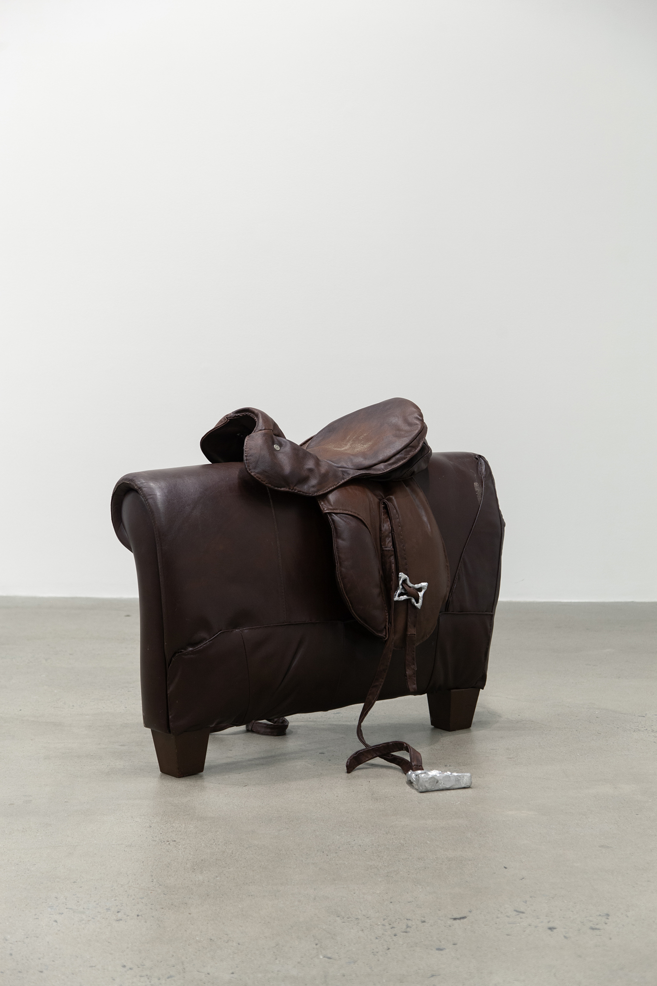 Cindy Hill, "Bridle Fantasy", used leather couch, deconstructed and hand-sewn back together, cast aluminum, 38â x 50â x 30â, 2023