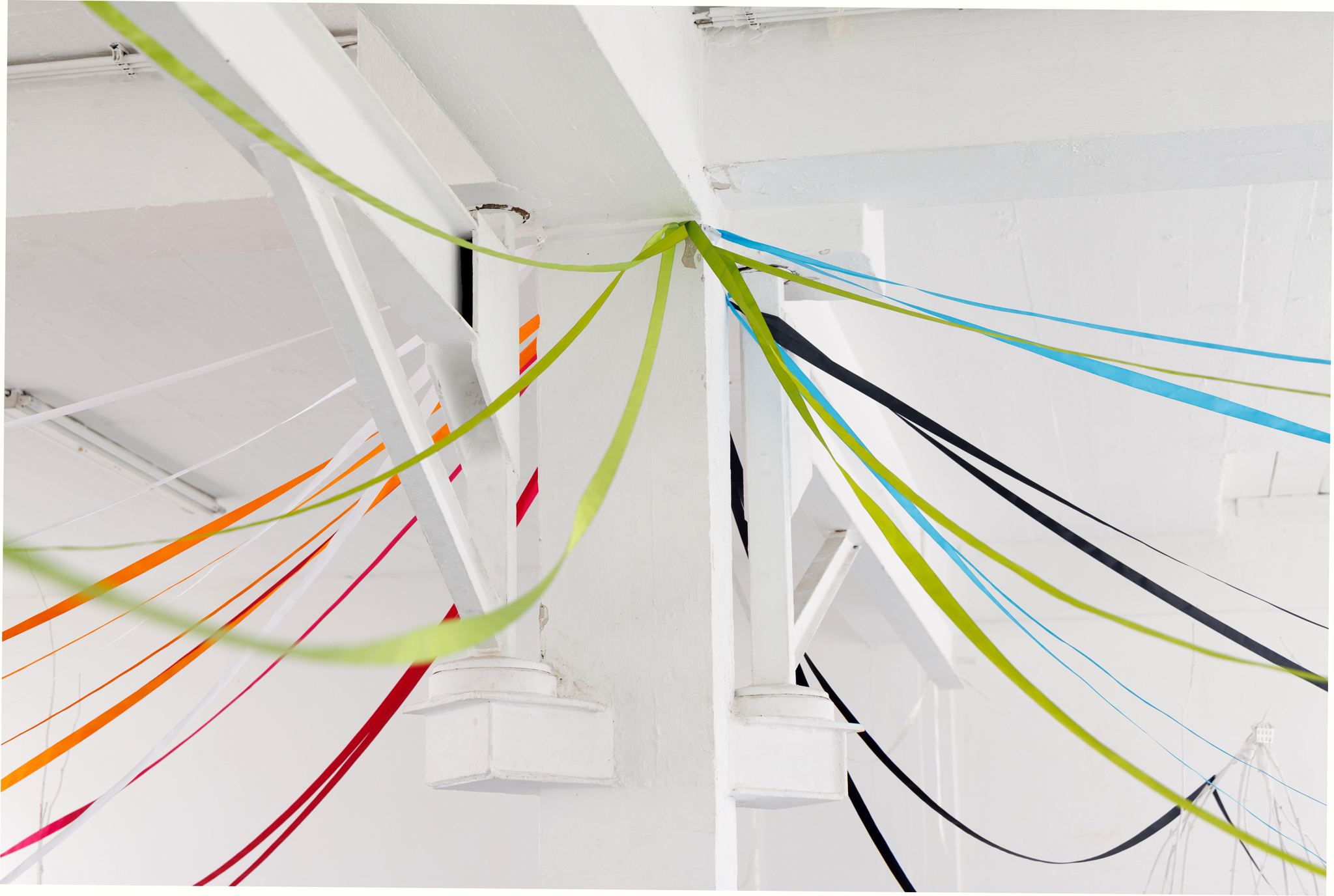 Anna Łuczak, Sophie Schmidt, “Brutality of Spring,” 2024, installation view (porcelain plates, white paint, wood ribbon, metal plate holders, cutlery, make up).