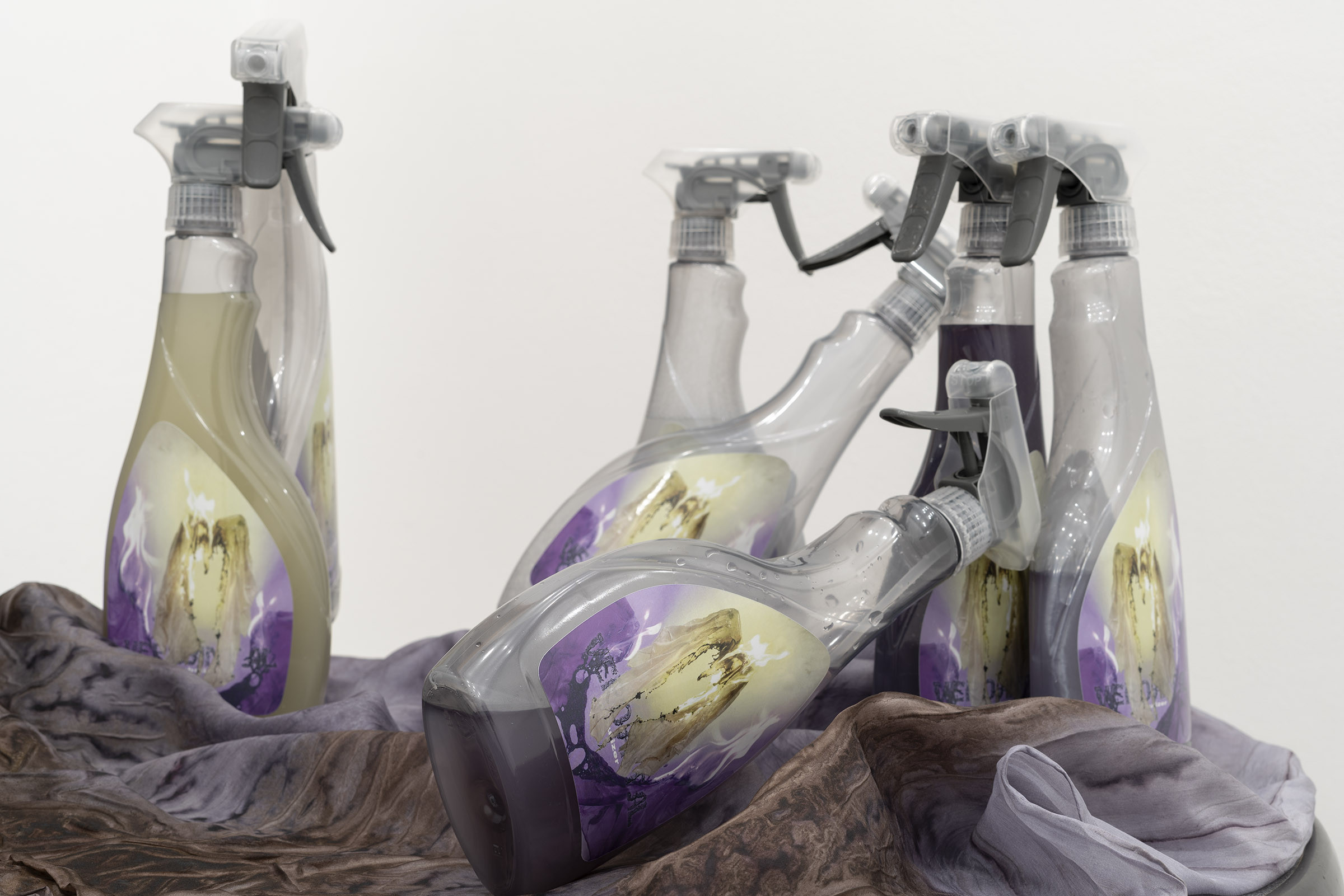 Marielena Stark, Verdant allies, 2025, Table, stickers, spray bottles, green tea, pastis, cochineal, rust, silk, 135 Ă 62 Ă 62 cm