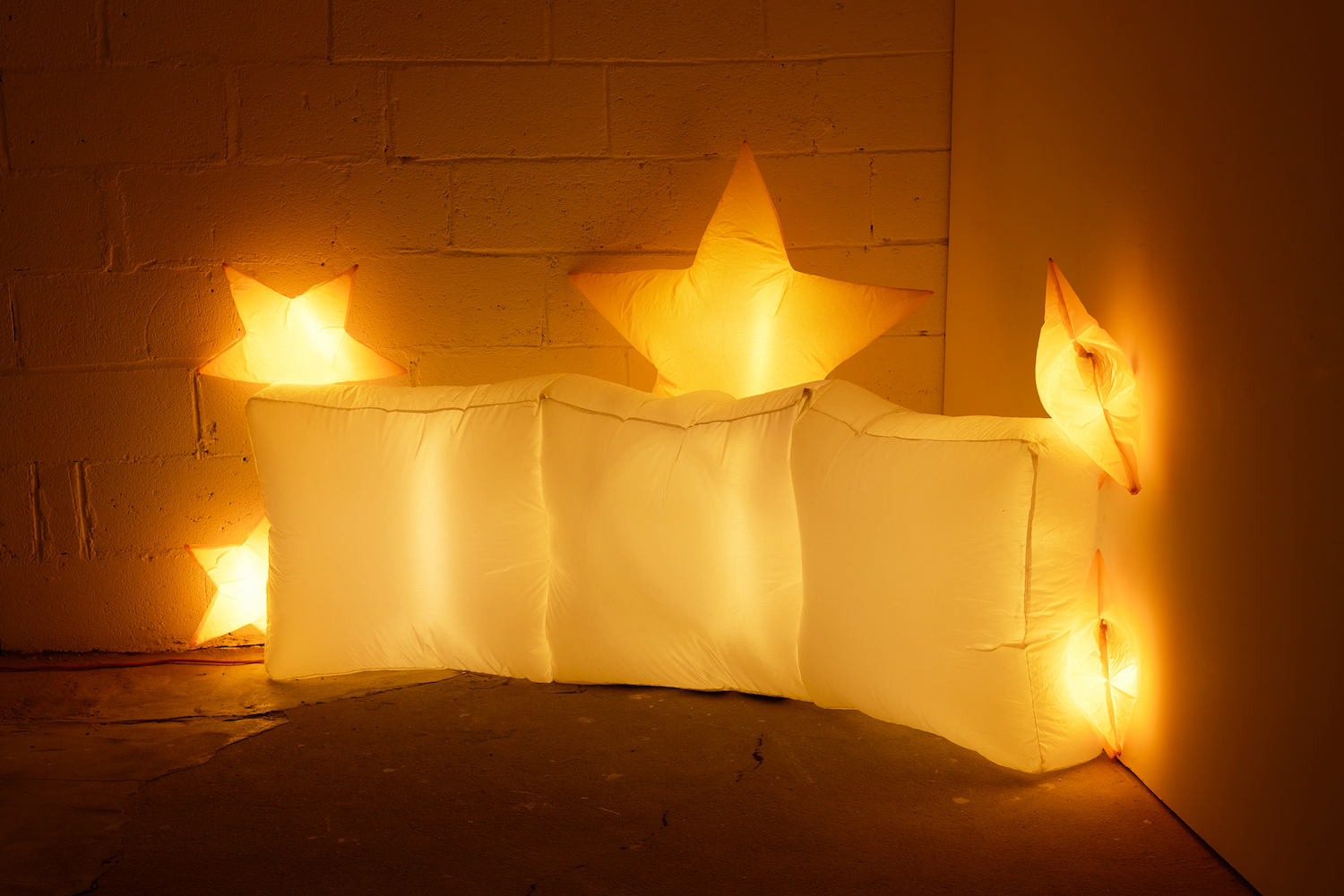 Jacob Jackmauh, âEvery Occasion,â 2025. Resewn polyester inflatable decoration, hand stitching, fan, LED lights, lighting gels, 45 x 86 x 25 inches