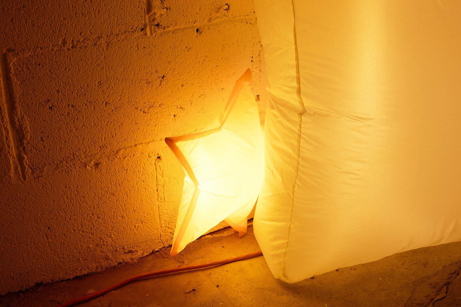 Jacob Jackmauh, âEvery Occasion,â 2025. Resewn polyester inflatable decoration, hand stitching, fan, LED lights, lighting gels, 45 x 86 x 25 inches