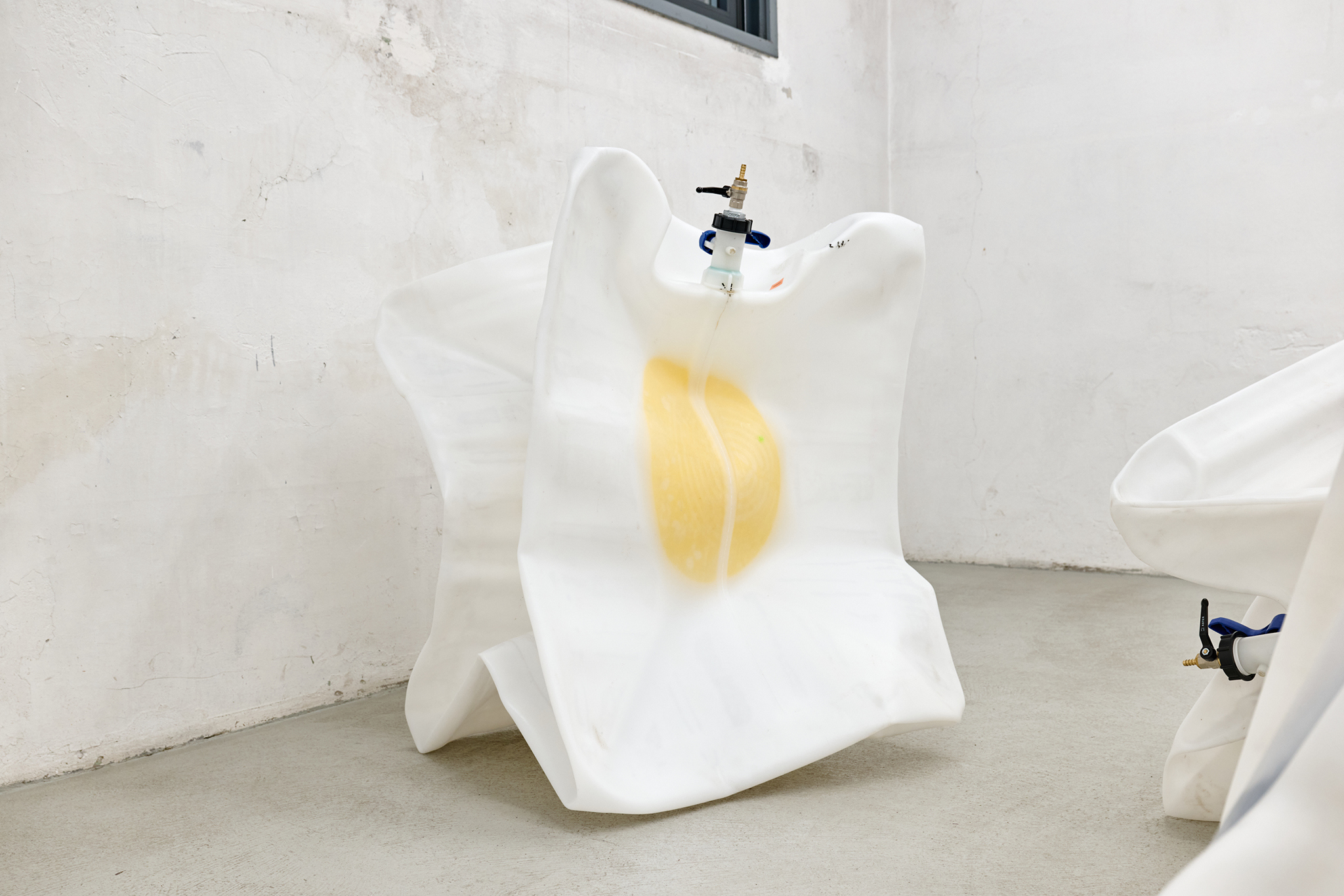 Sacha Kanah, Watermelons in Easter Hay, 2025, IBC, valve, rubber ball, paint, bleach, vacuum, 80 x 96 x 116 cm