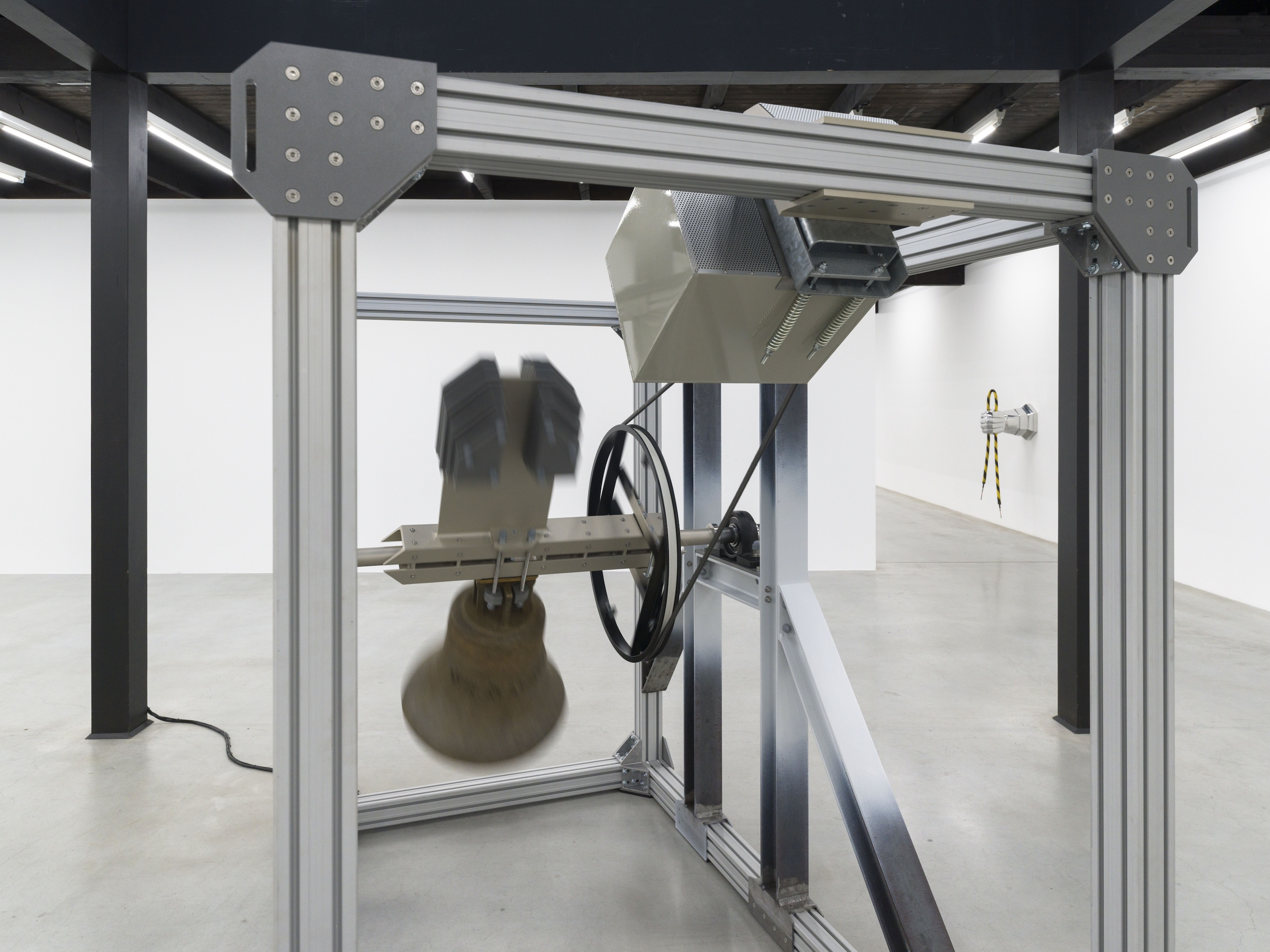 Jonas Roßmeißl, Glocke, 2025. 1460x1930x2300. Bronze, B-type aluminium system profile, HEB 100 steel girder, drive, clapper, chime, control. Installation view. Courtesy of the artist and Oldenburger Kunstverein. Photo: Roman März.