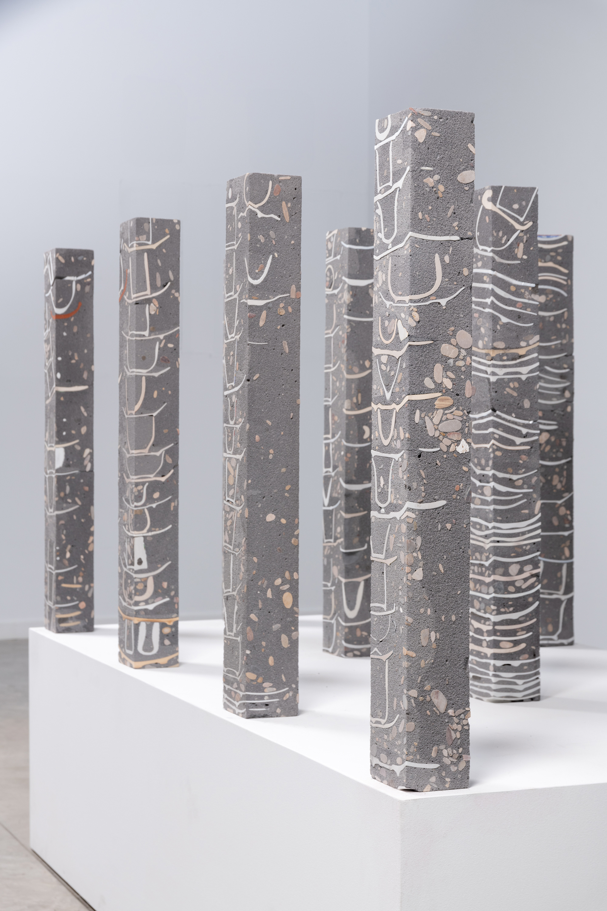 Javier Carro Temboury, Café Transversal V, 2025, Ceramic cups and dishes, organic leftovers, cast in concrete then cut. 76 x 10 x 8 cm each.