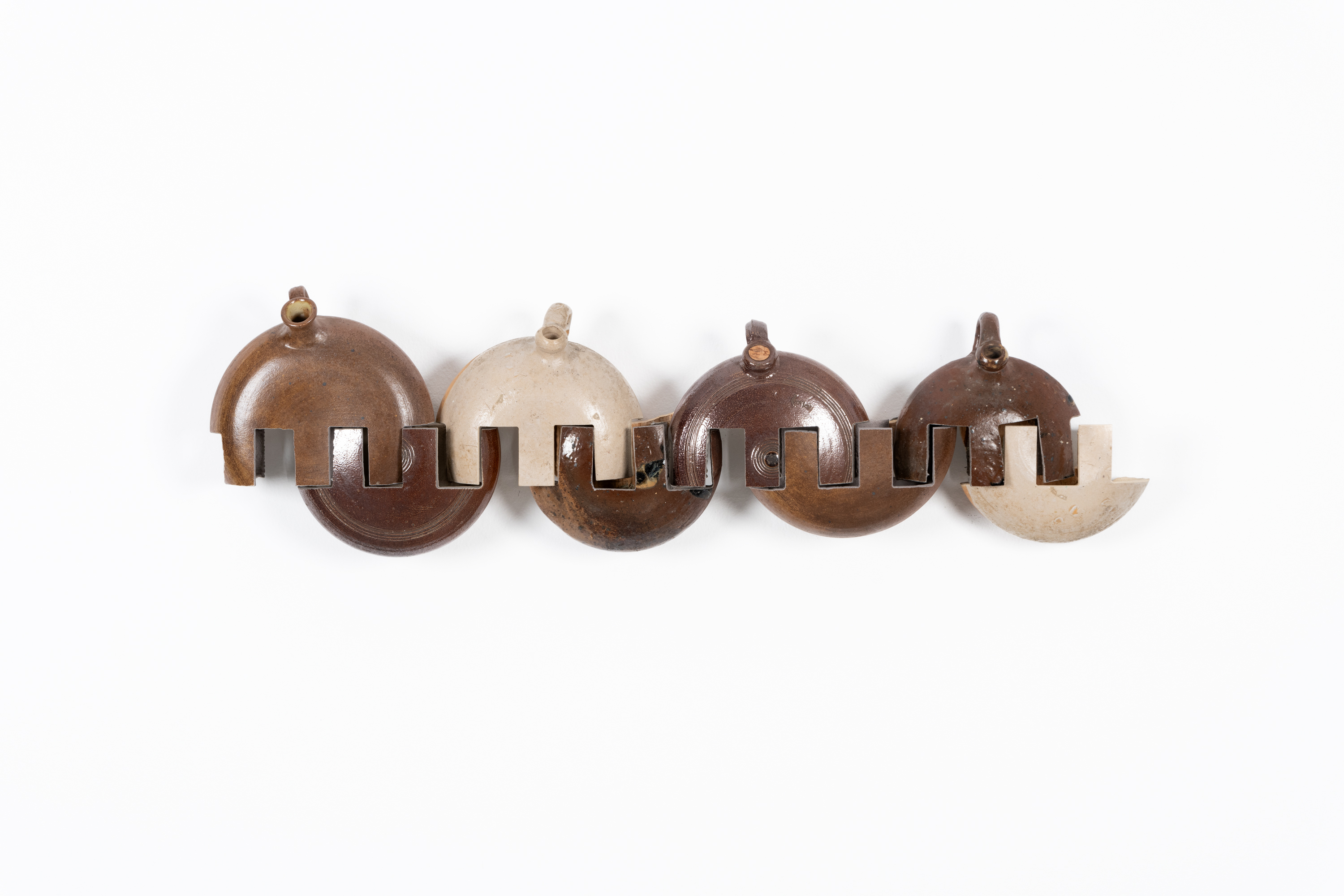 Javier Carro Temboury, Intercontainers (Bouillottes, La Borne), 2024, Second-hand ceramic hot water bags, industrial cut. 100 x 30 x 12 cm