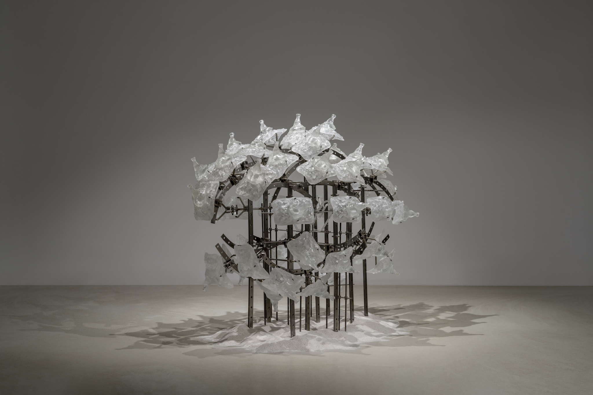 shy but ok (like being thirsty), 2024, stainless steel, epoxy, mutant glass bottle, white sand