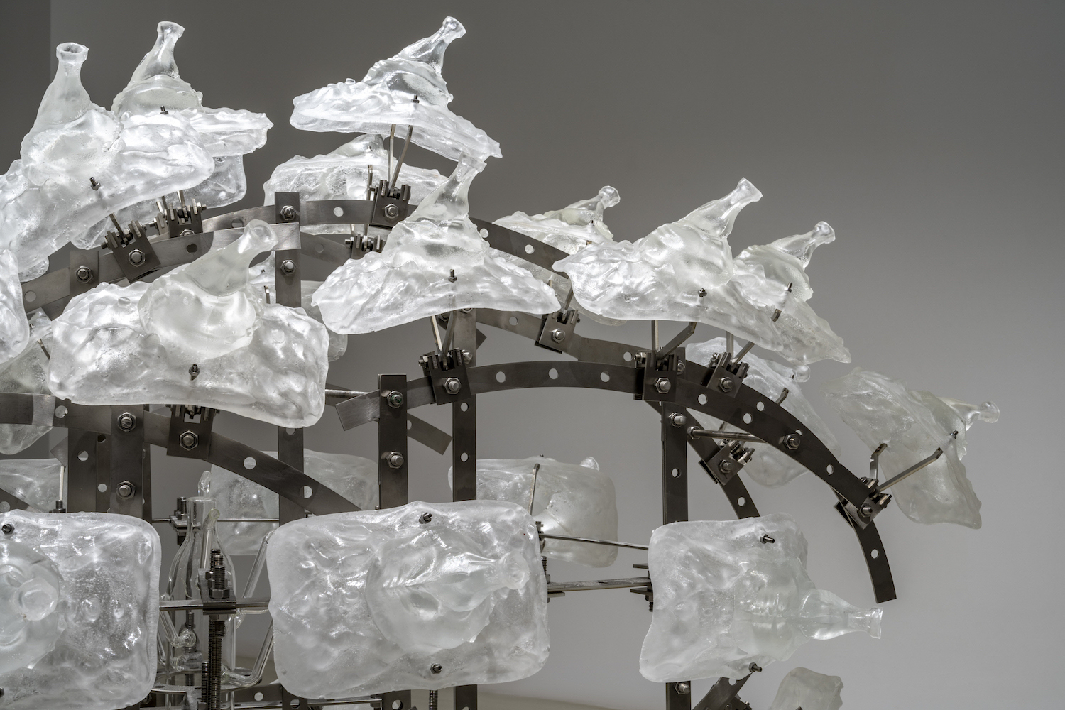 shy but ok (like being thirsty), 2024, stainless steel, epoxy, mutant glass bottle, white sand