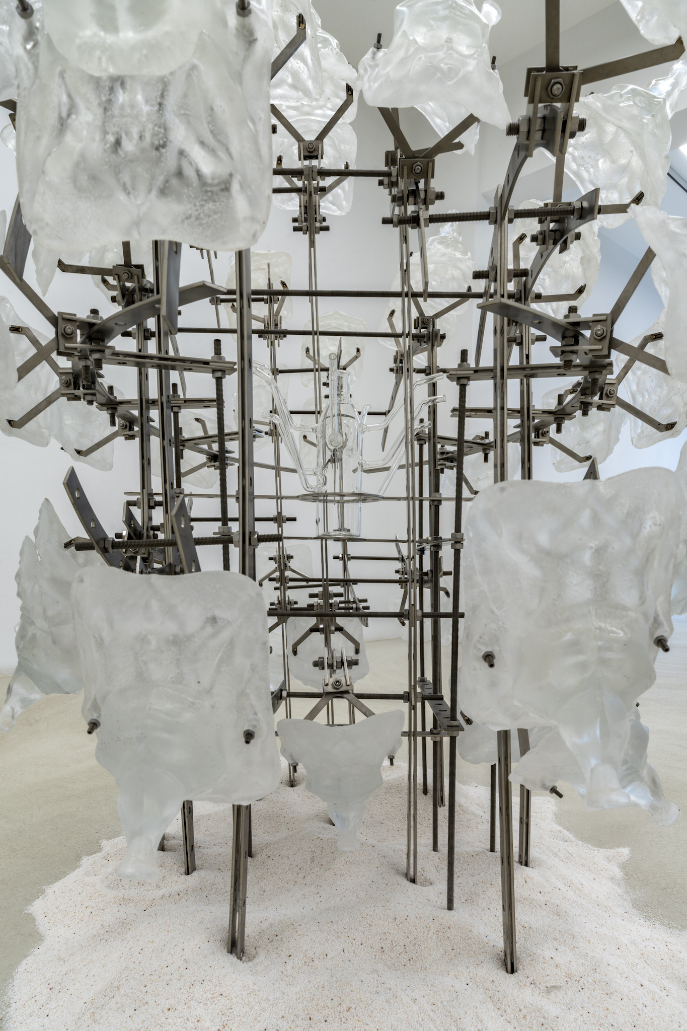 shy but ok (like being thirsty), 2024, stainless steel, epoxy, mutant glass bottle, white sand