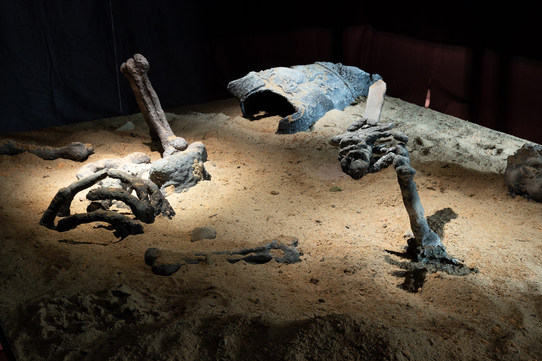 Excavation site. Plaster sculpted artifacts, clay artifacts, sand. 3 x 2 x .8 m 2025. Photo: Jane Treima