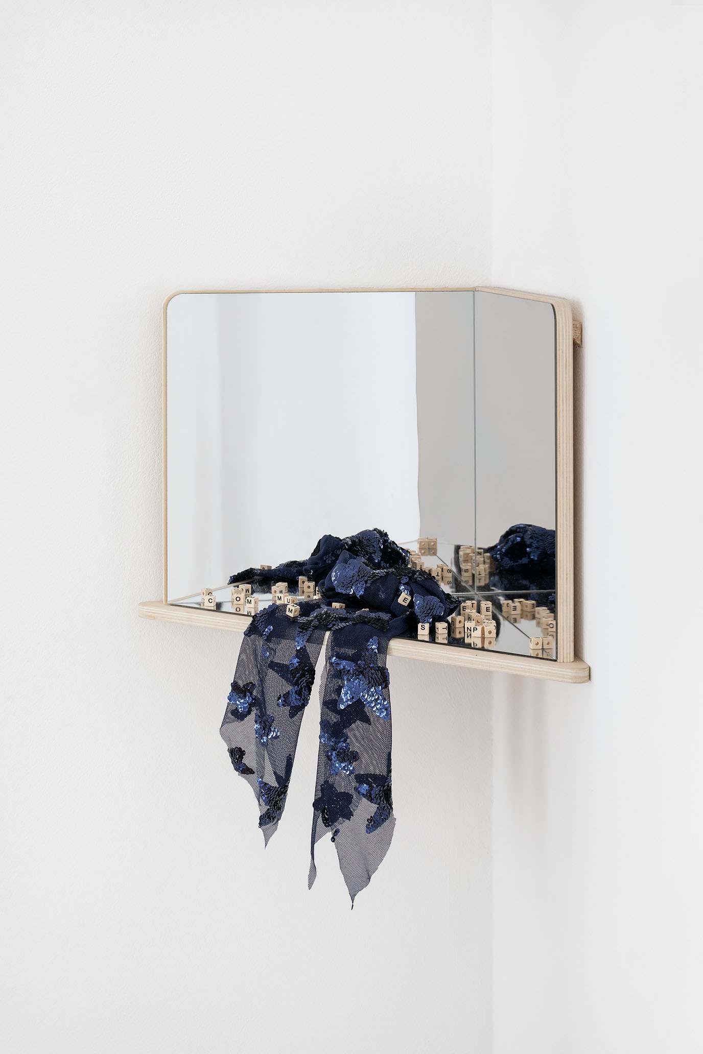 Jiajia Zhang, Who is she? (a mime, a communist, a student protester), 2024. Child education mirror, wooden alphabet beads, fabric bow, sticker, 29.9 cm x 45.7cm x 23.8 cm