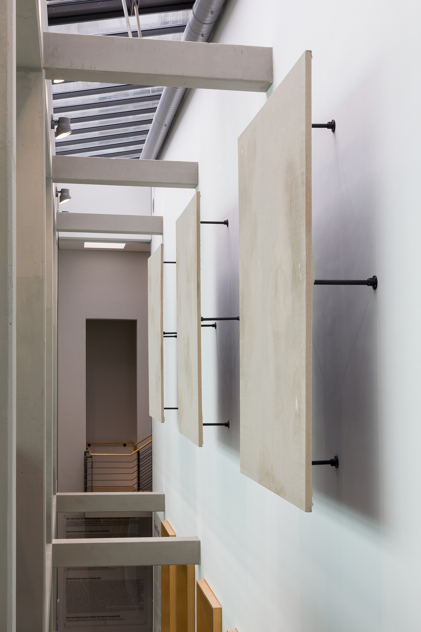 Background Vehicle (Running Scene), 2025. Plotter print on canvas with marker, paint, covered with a layer of raw linen with marker, glue, detergent, oil, wall filler. Suspended 45 cm from the wall with metallic poles. Triptych, 245 x 163 x 3,5 cm each