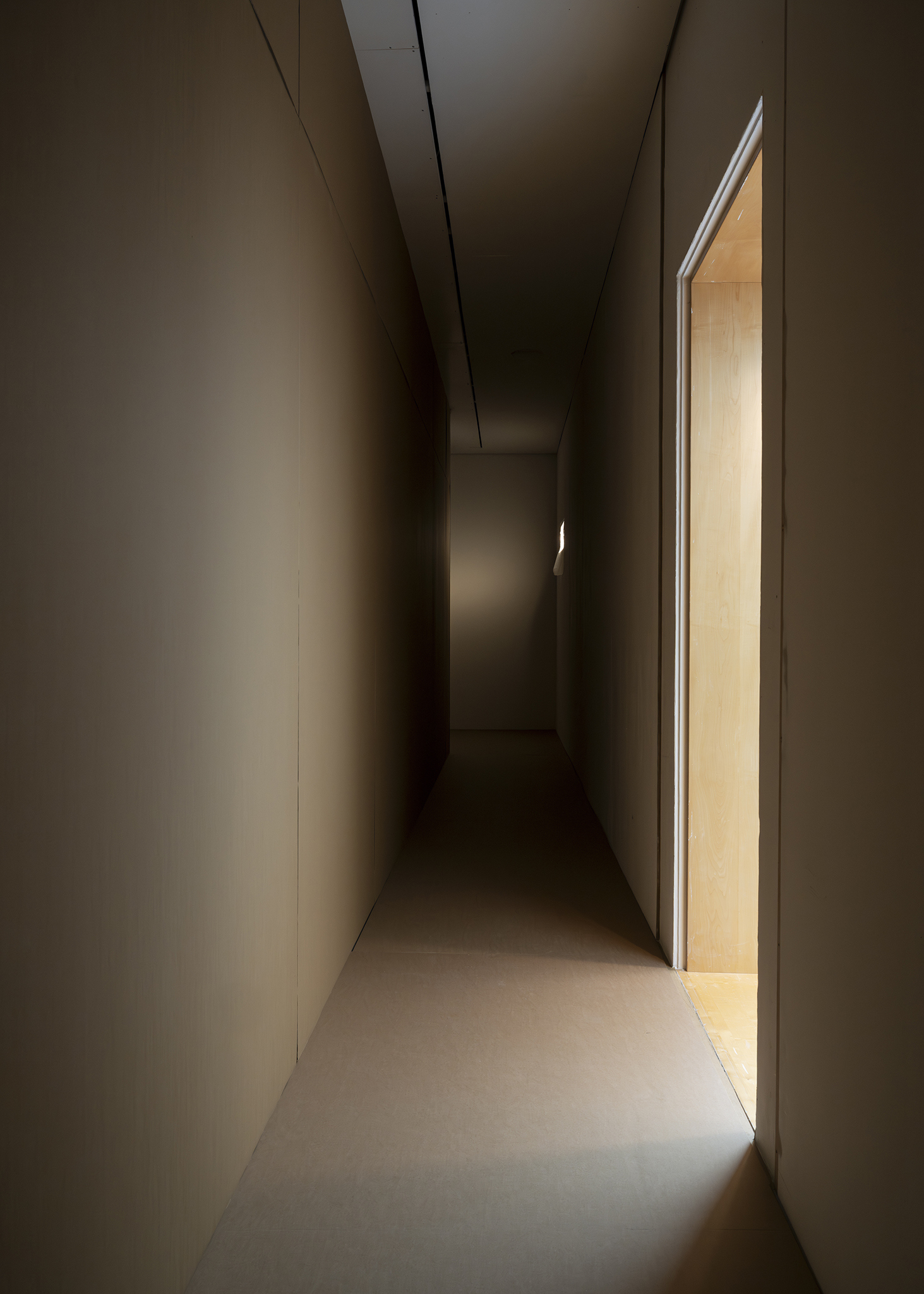 Thereafter, 2025. Environment consisting of cardboard walls and floor, wall cutouts with plastic film, sound, light intervention, alteration of the main entrance. Site-specific dimensions.
