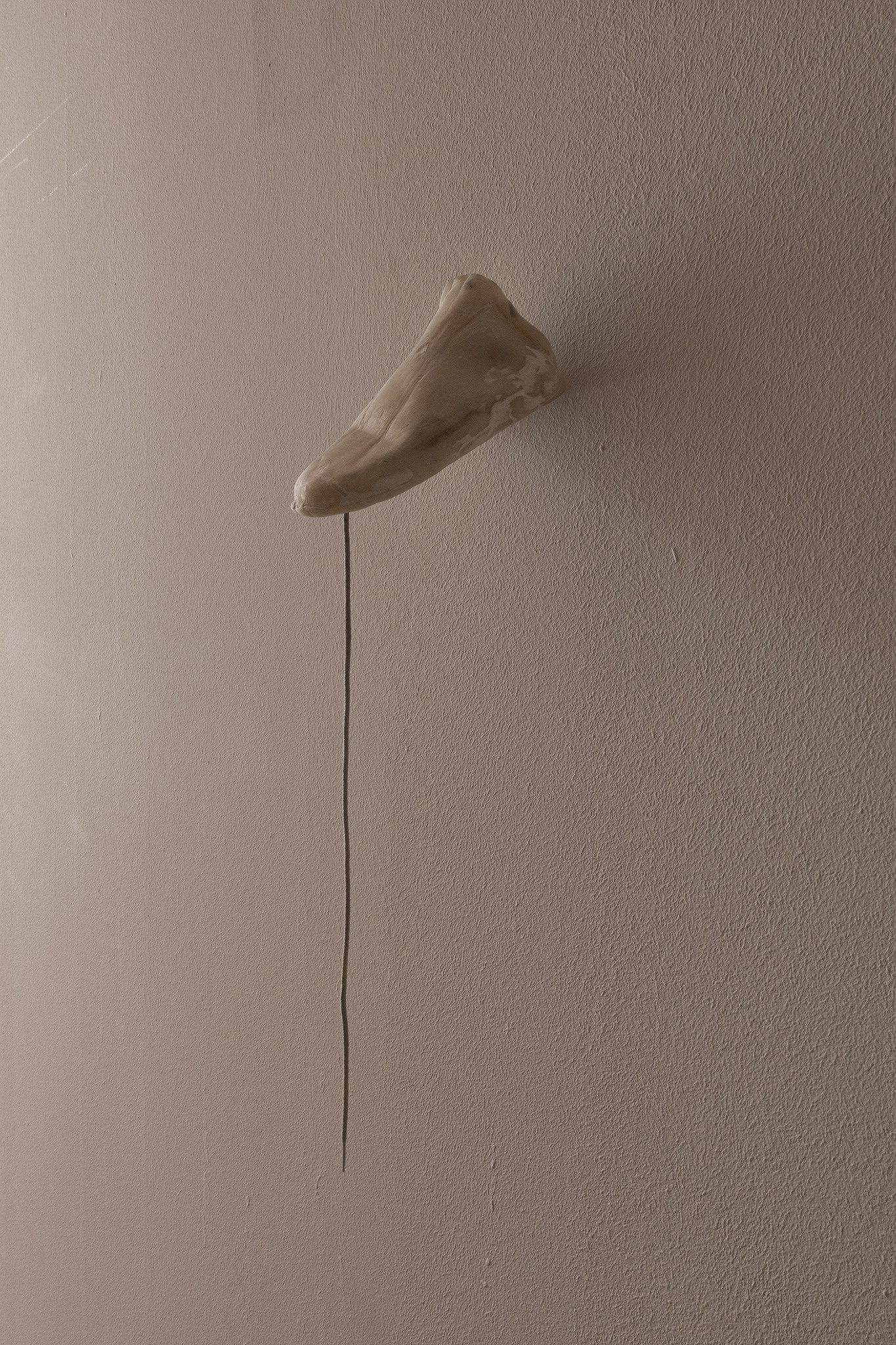 Bystander (Ankle), 2025. Air-dry porcelain, wood filler, shoe lace. 8 x 16,5 x 7,5 cm