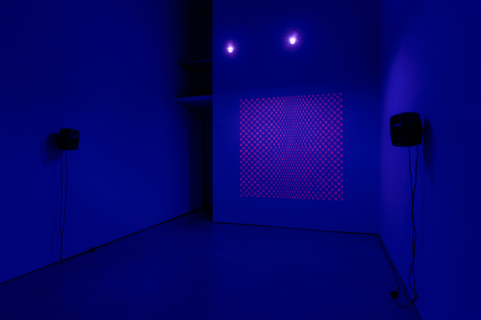 Nour Mobarak Subliminal Lambada/Subliminal Riley, 2023-2025 sound installation (stereo digital audio, glow in the dark paint on wall, black light) 30:20 min