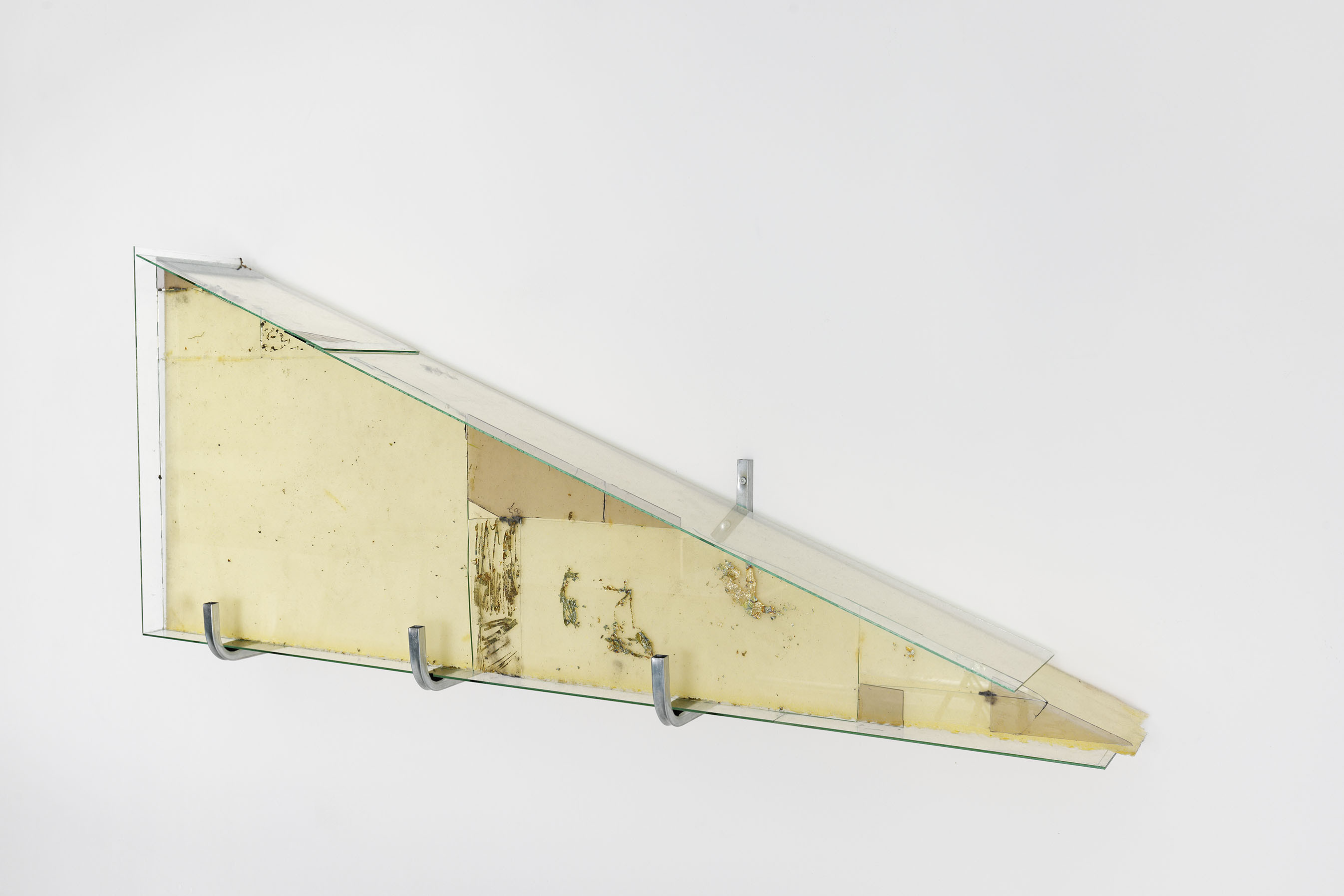 Triangle Foam wrapped in Glass, 2025, Foam, glass, dust, imitation gold leaf, 56 x 135 x 22 cm