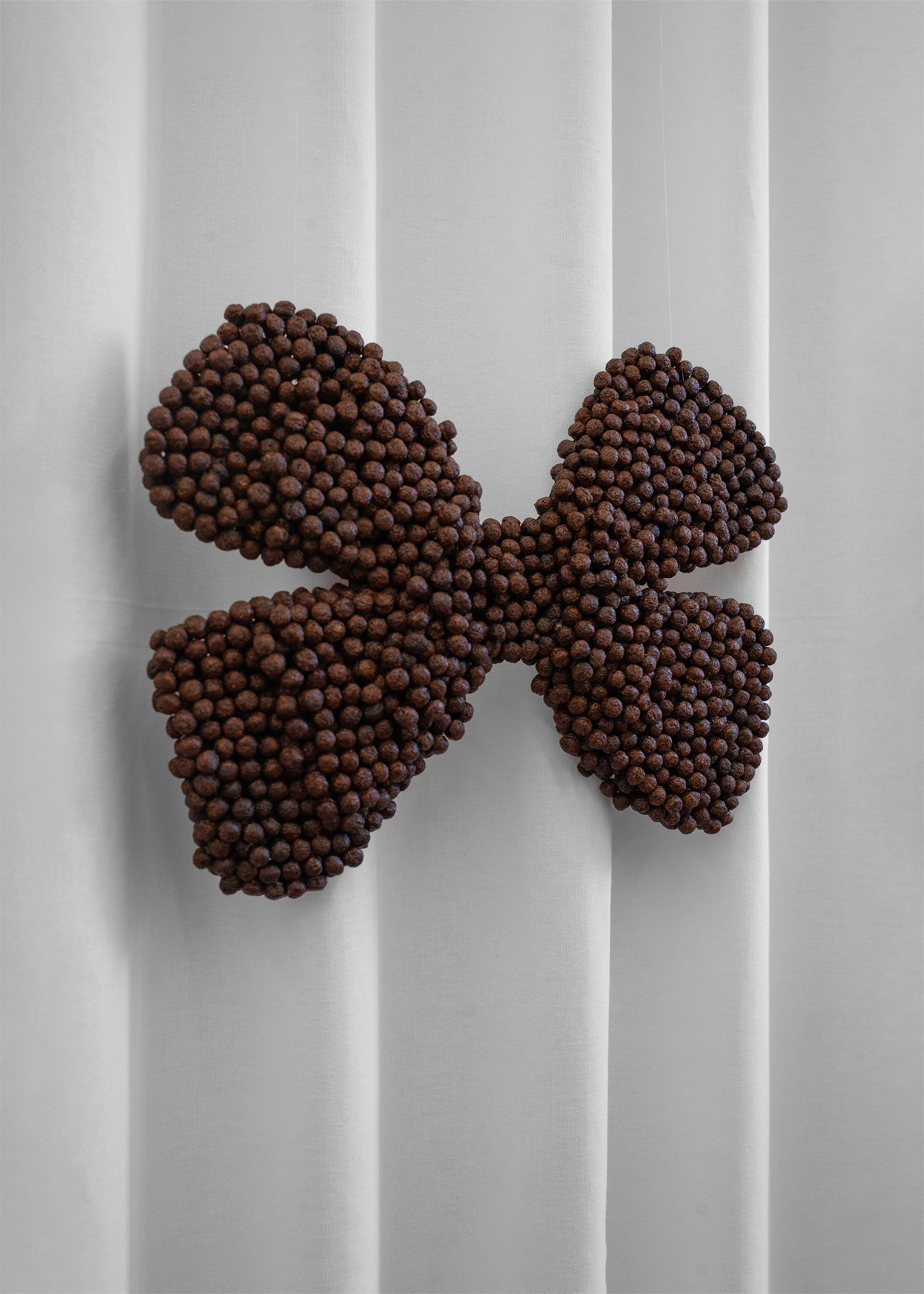 Iuliia Skromnaya, "Choco Bow", 2025, Object, Nesquik, 26 х 40 х 3,5 cm 