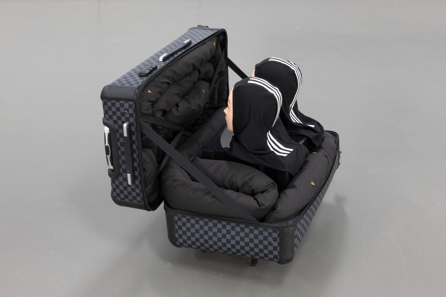 Yeşim Akdeniz, Representations #2, 2025. Luggage, textile, upholstery, wood, mannikin heads, plastic bucket, 80x70x65cm.
