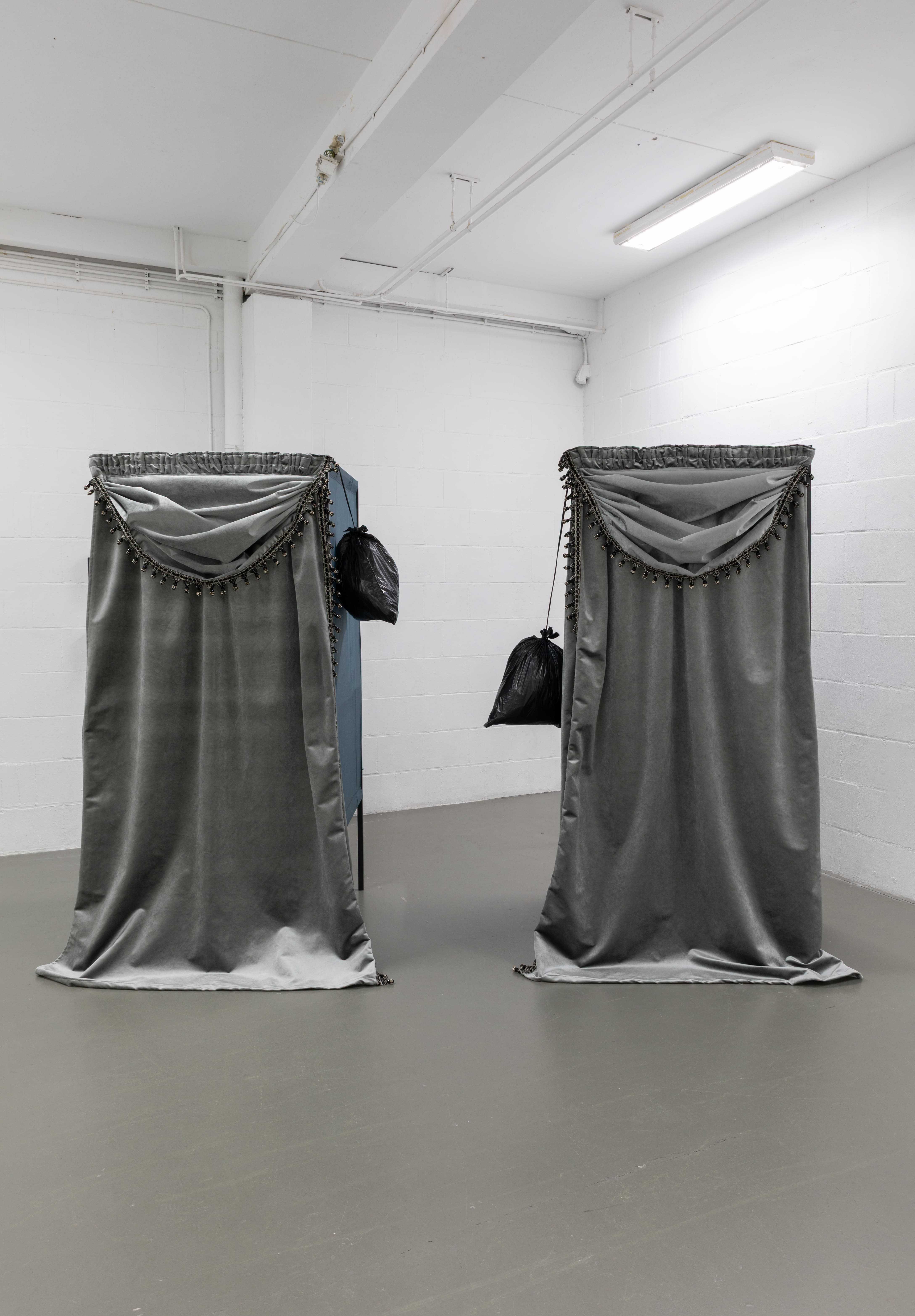 Yeşim Akdeniz, Repeated Temporary, (2025). Standard voting cabin, curtain, trash bag, rope. 200x90x120cm each.