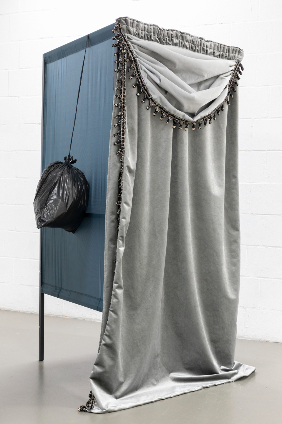 Yeşim Akdeniz, Repeated Temporary, (2025). Standard voting cabin, curtain, trash bag, rope. 200x90x120cm each.