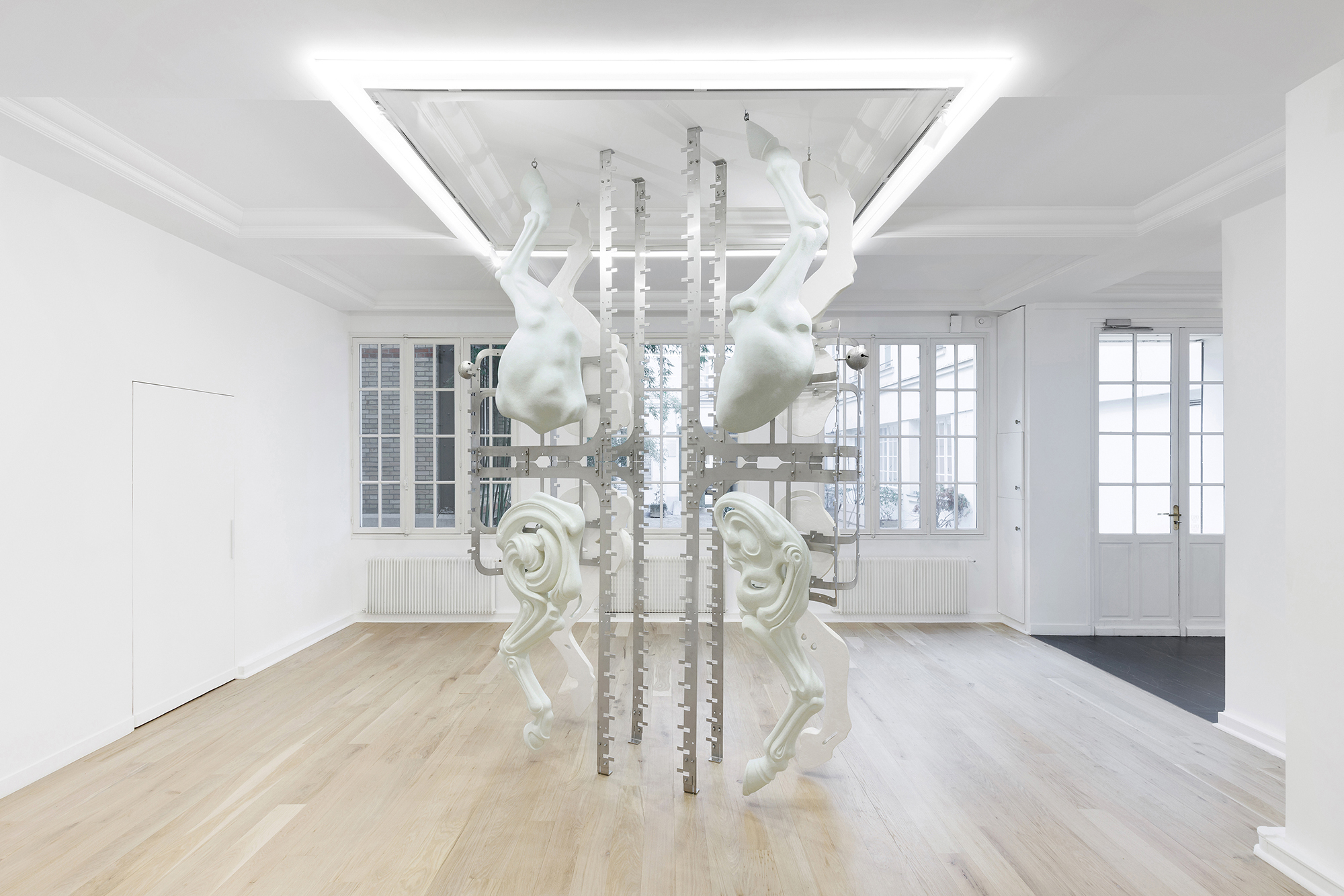 Midway Kin, 2025, hand-sculpted - acrylic plaster, fibers, pigments, stainless steel, tin bells, installation view