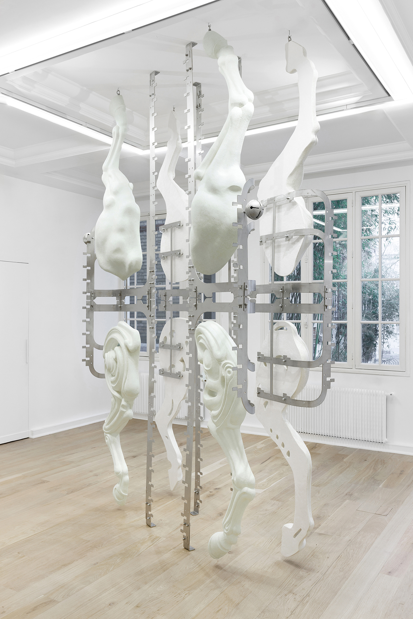 Midway Kin, 2025, hand-sculpted - acrylic plaster, fibers, pigments, stainless steel, tin bells, installation view
