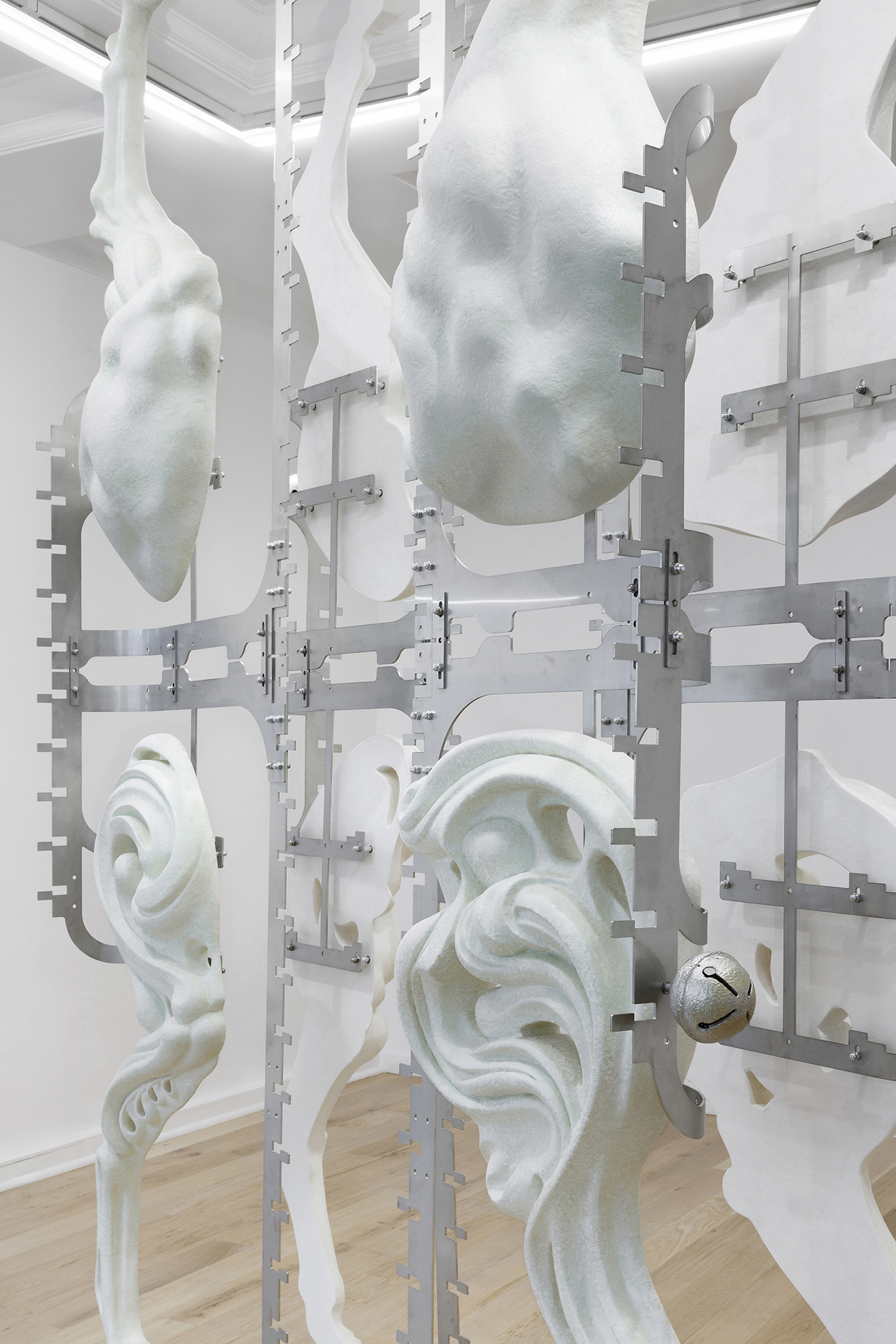 Midway Kin, 2025, hand-sculpted - acrylic plaster, fibers, pigments, stainless steel, tin bells, installation view