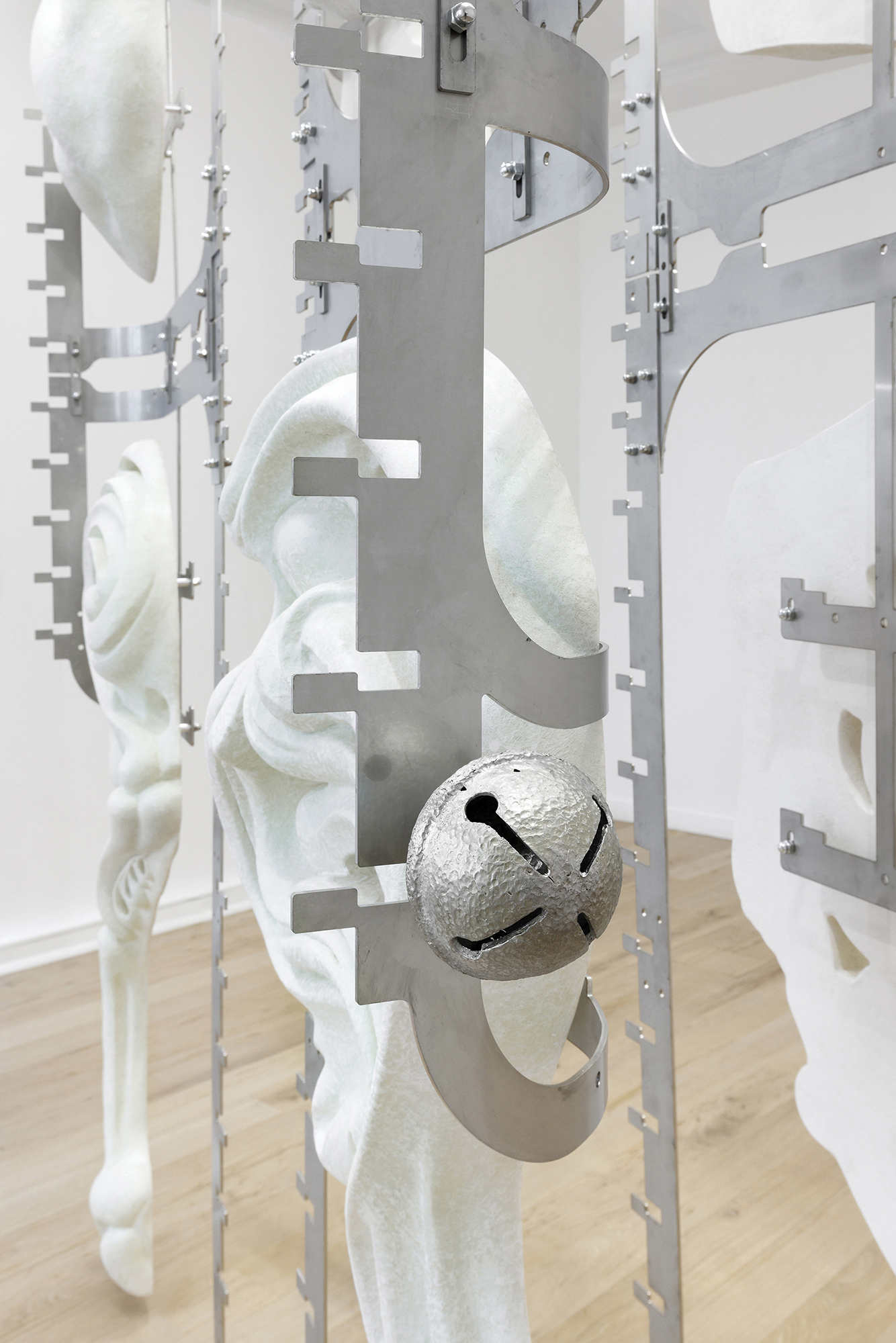 Midway Kin, 2025, hand-sculpted - acrylic plaster, fibers, pigments, stainless steel, tin bells, installation view