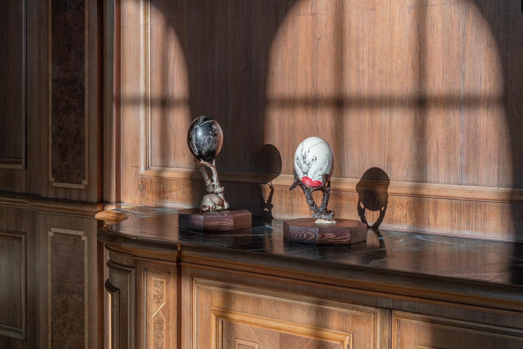 THE KETCHUP SONG/ASEREJÉ (LAS KETCHUP), 2025 ink, saliva, blown ostrich egg, roe deer skulls and antlers, wooden plinths