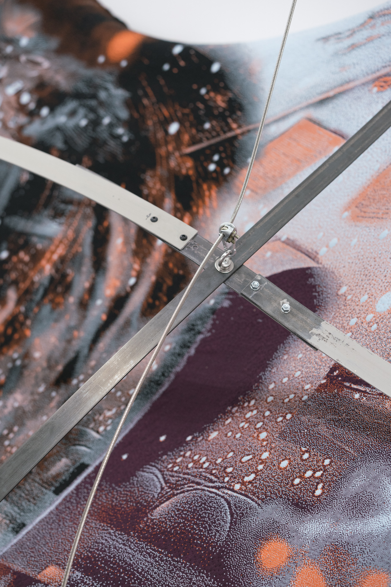 Nicola Arthen - Reading A Reflection (2025); Collage from generated images, machine-knitted wool, cotton and filling yarn, steel rig, C-prints, wooden carts with engravings, work pants, lights, sensors (760x160x145cm), courtesy of the artist and Platform