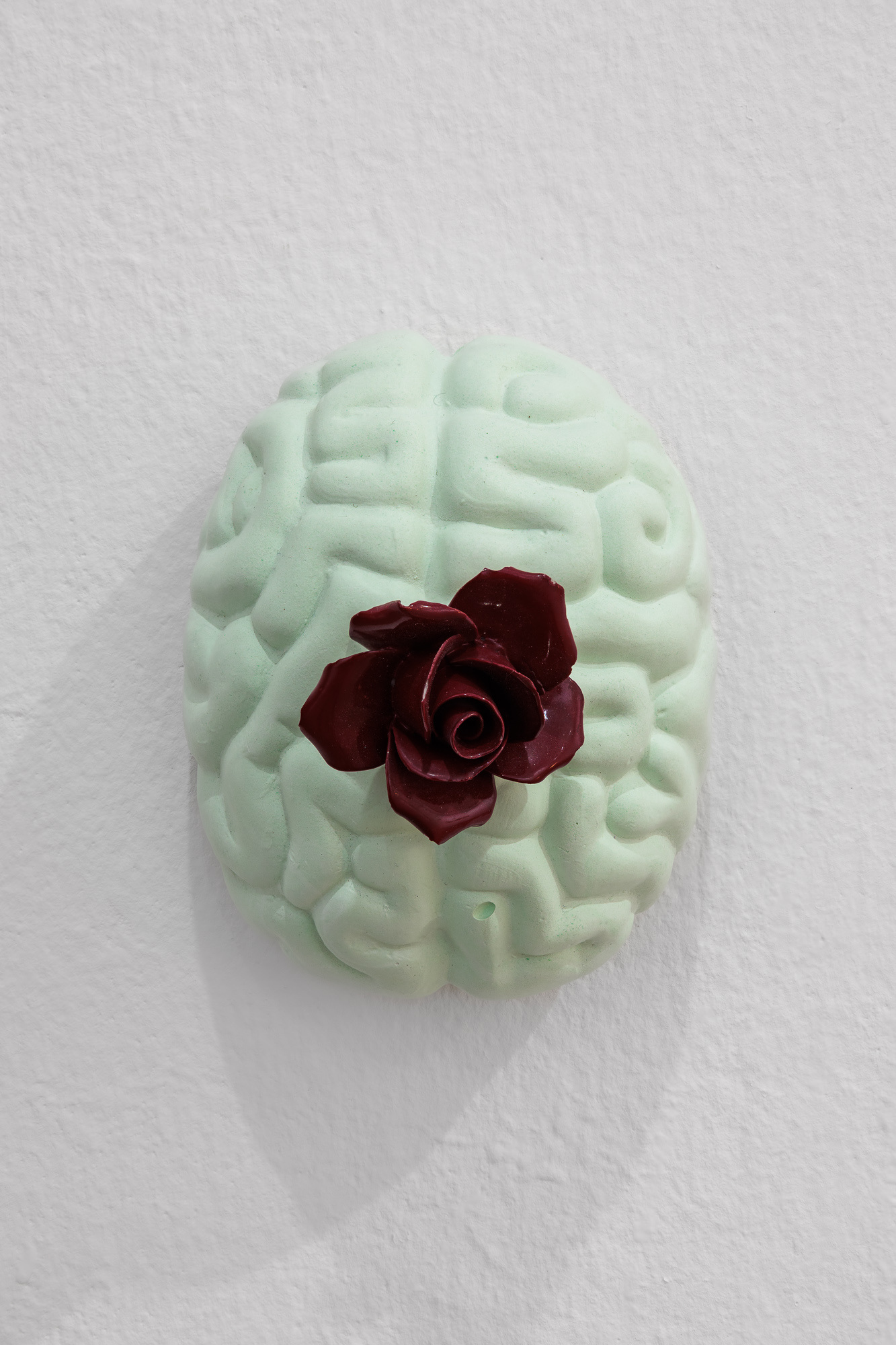 Daphne Ahlers, Flower Brain, 2022 plaster, porcelain rose, ink, aluminum 12 x 10 cm