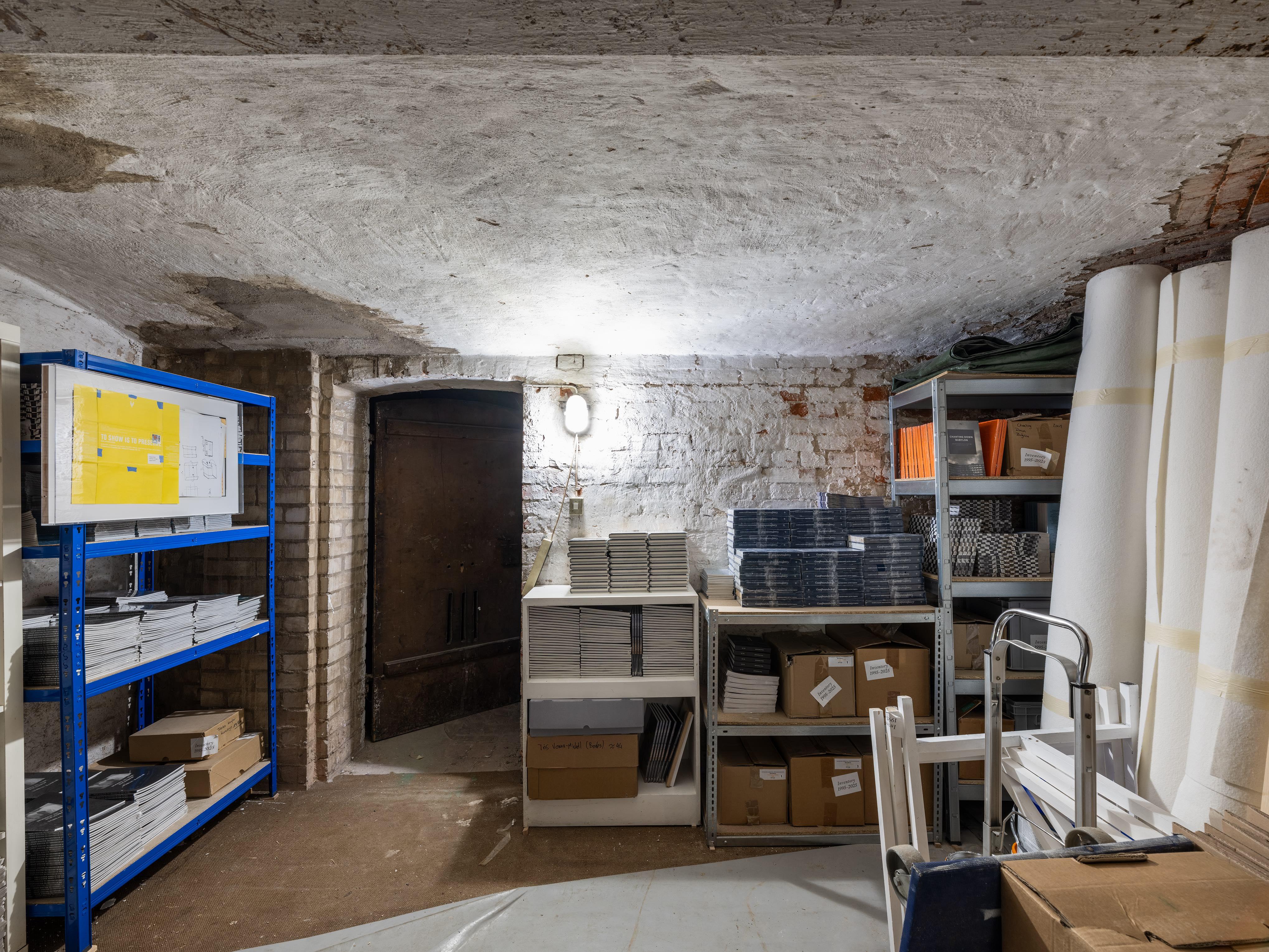 Exhibition view (Storage space), To Show is to preserve (2008, 2025), Acrylic glass cover, document, inkjet print on Hahnemühle Photo Rag, birch plywood with white melamine, 45x73,8x4cm, 2025, Photography: Fred Dott