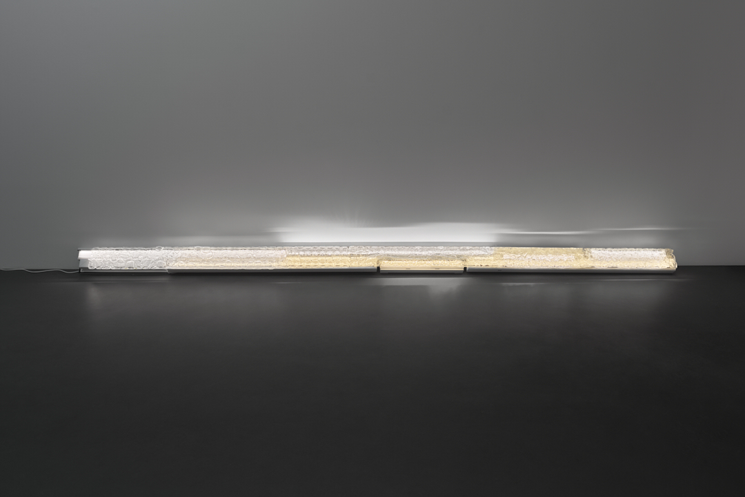 EWAESST, 2025, melted cupping glass, PVC window frame, light, 14x366x10 cm