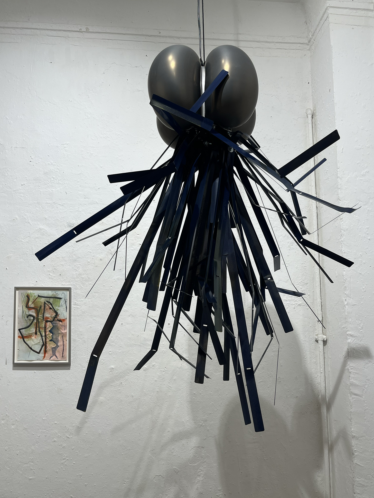 Theresa Hartmann, sound contact/Sonarkontakt, 2026: "You can carefully press a lamella to your ear." / behind: Benjamin Bernt, wilted warnings, 2025