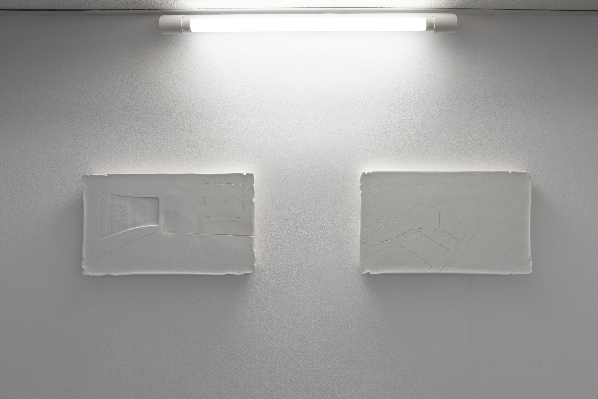 Iga Niewiadomska, „After interrogation” and „Hatch”, 2023, plaster reliefs, 21 × 36 × 2.5 cm each